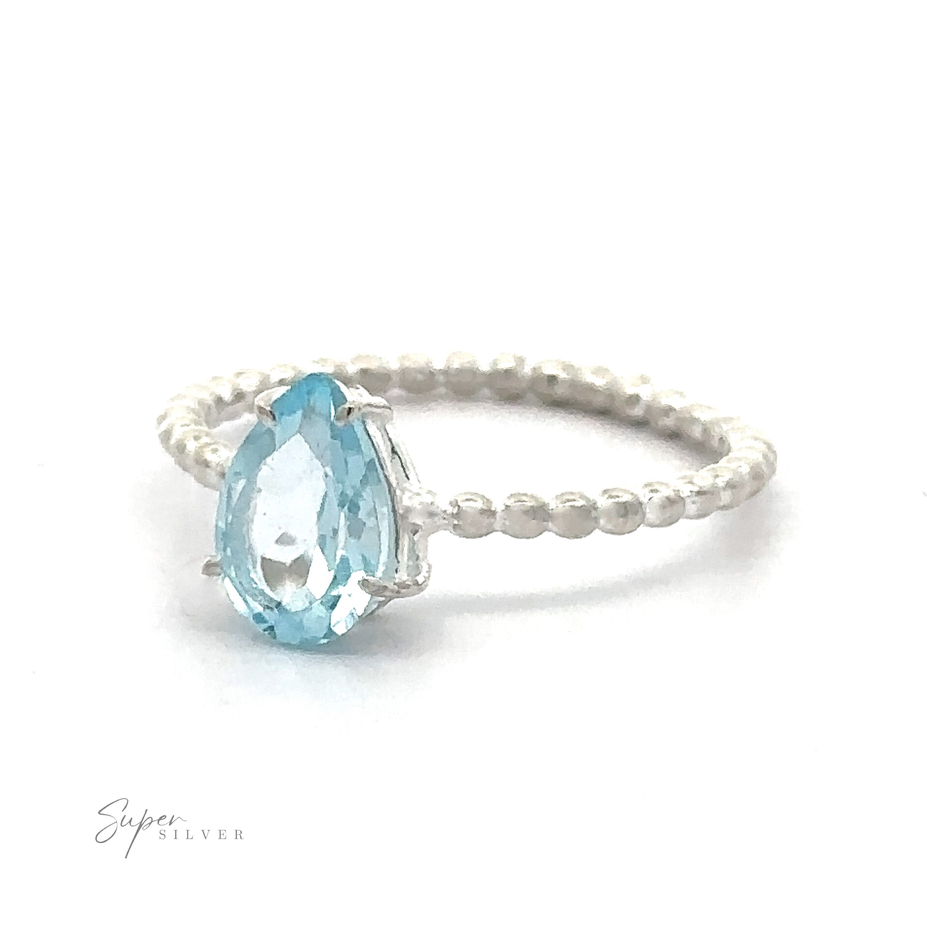 A Vibrant Teardrop Gemstone ring with a teardrop-shaped blue gemstone on a white background.
