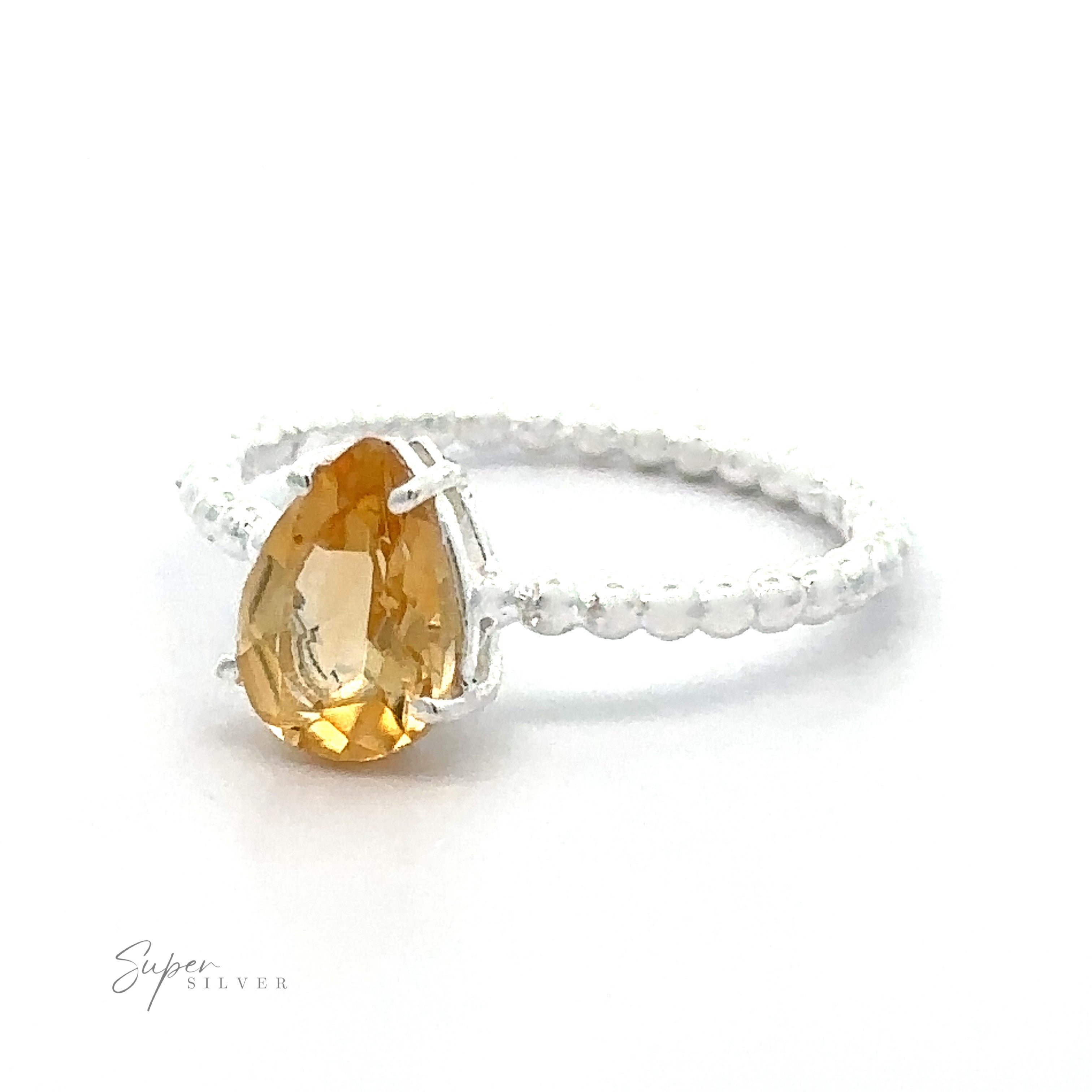 A Vibrant Teardrop Gemstone Ring with Beaded Band on a white background.