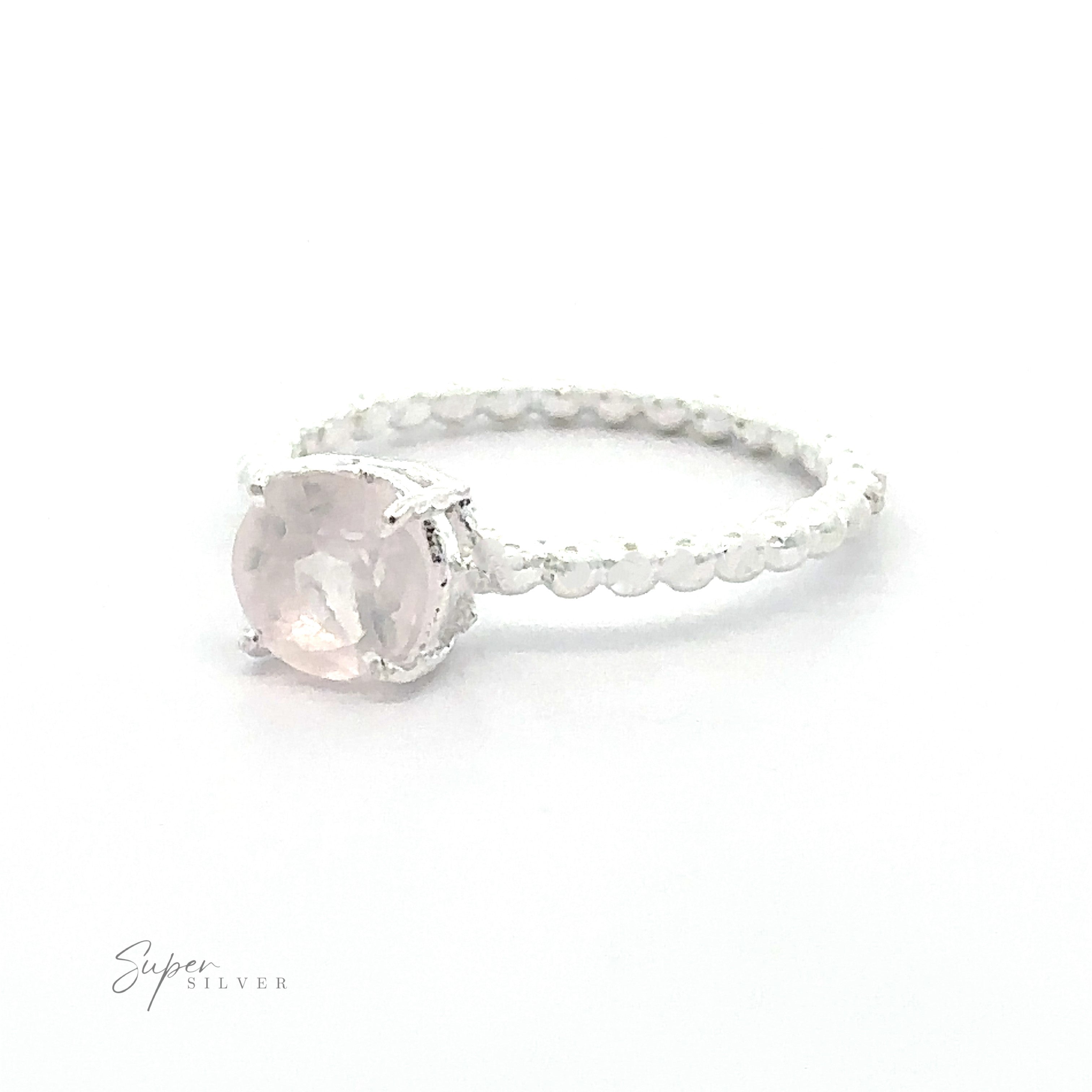 Stunning Circular Gemstone Ring with a vibrant pink gemstone and decorative silver band, against a white background.
