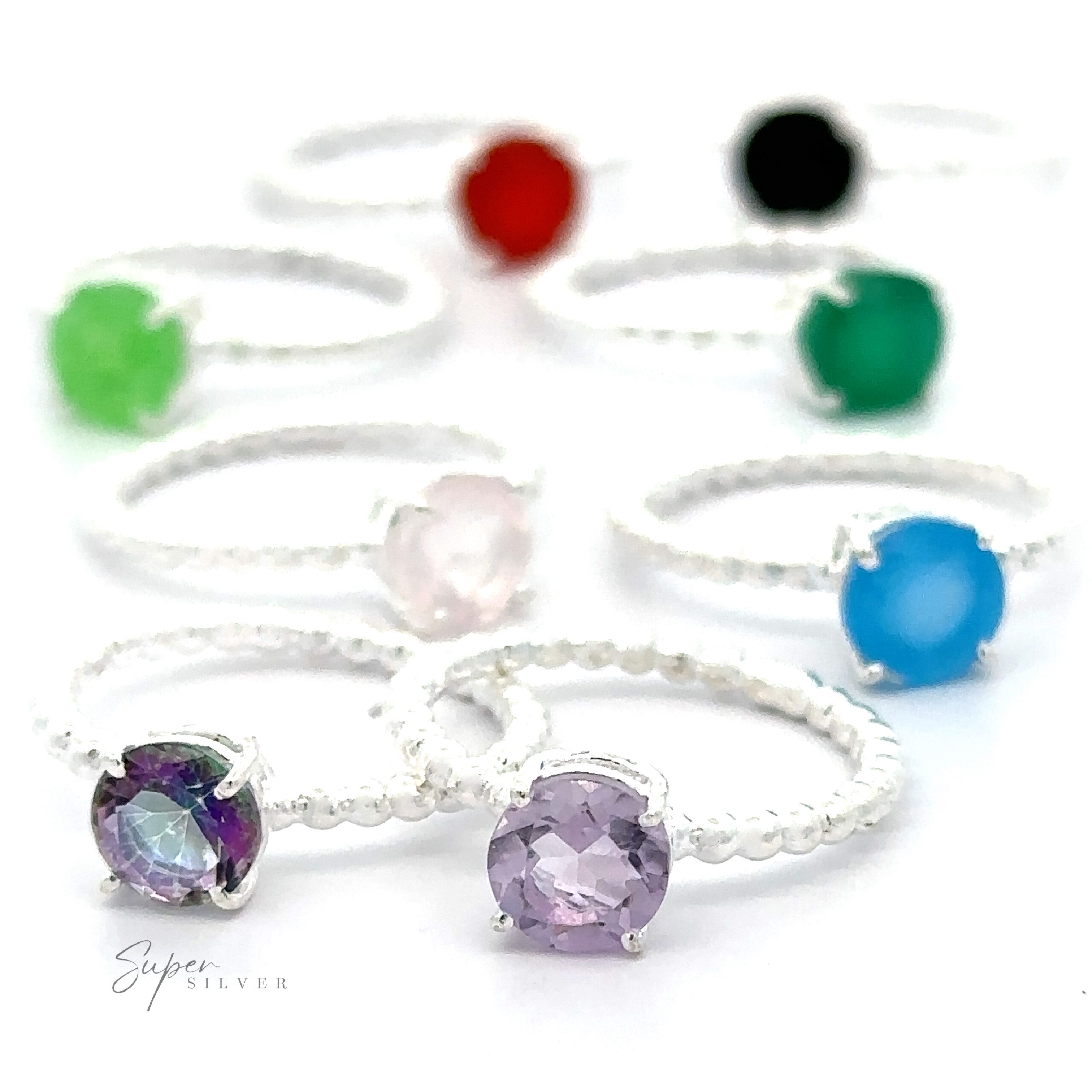 A collection of stunning circular gemstone rings with beaded bands in small sizes displayed on a white background.