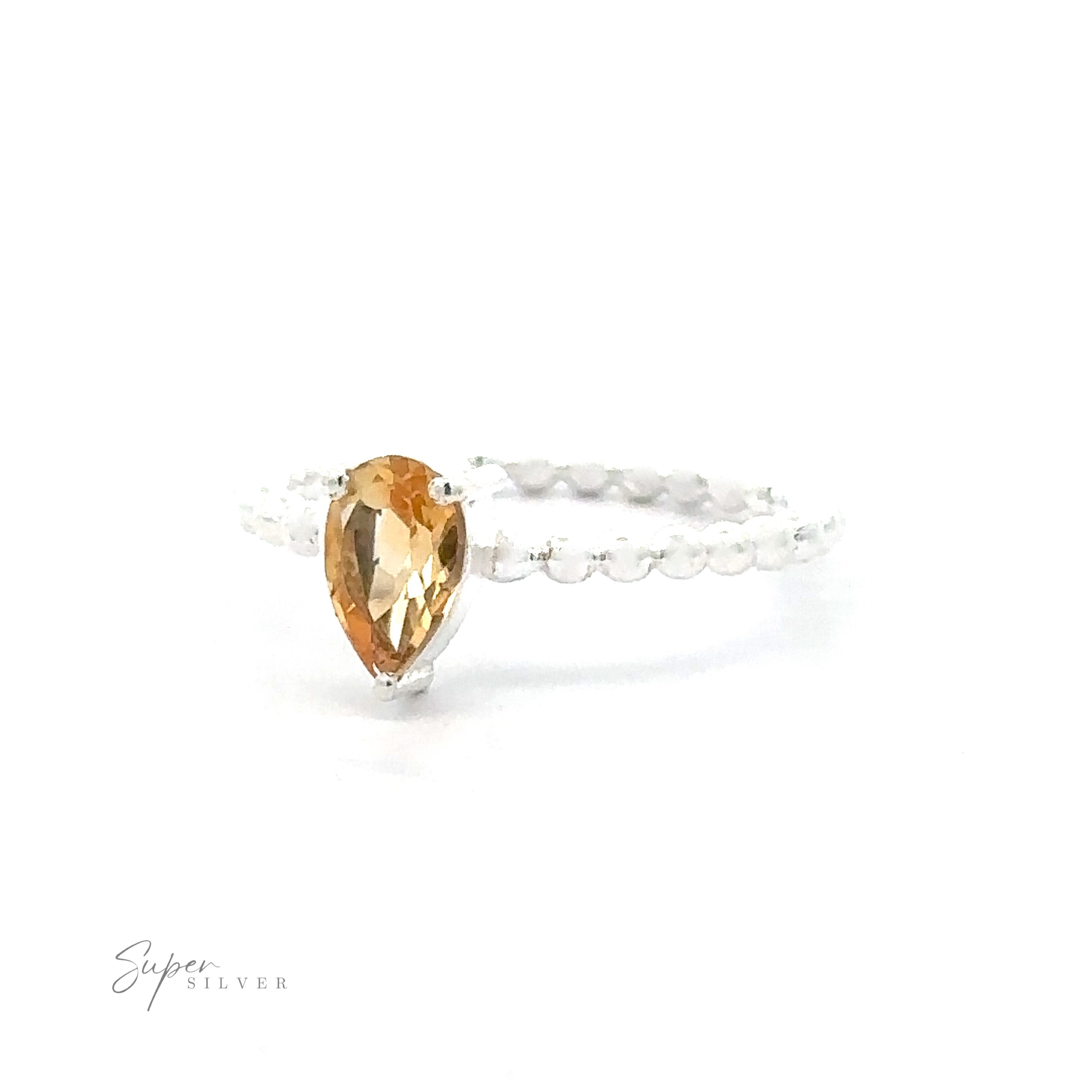 Sparkling Teardrop Gemstone on Beaded Band ring on a white background.
