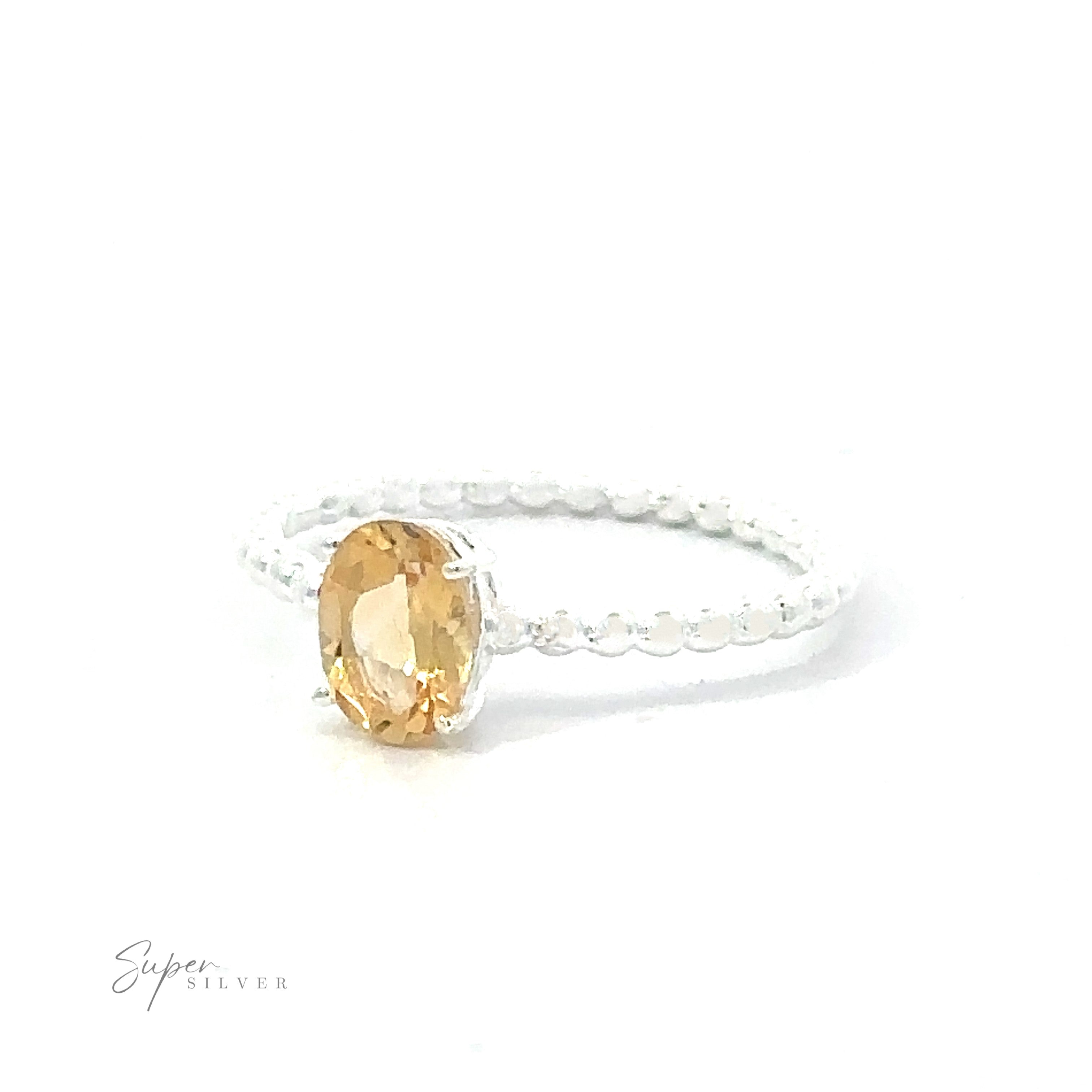 Stunning Oval Gemstone Ring with Beaded Band with an oval yellow gemstone on a white background.