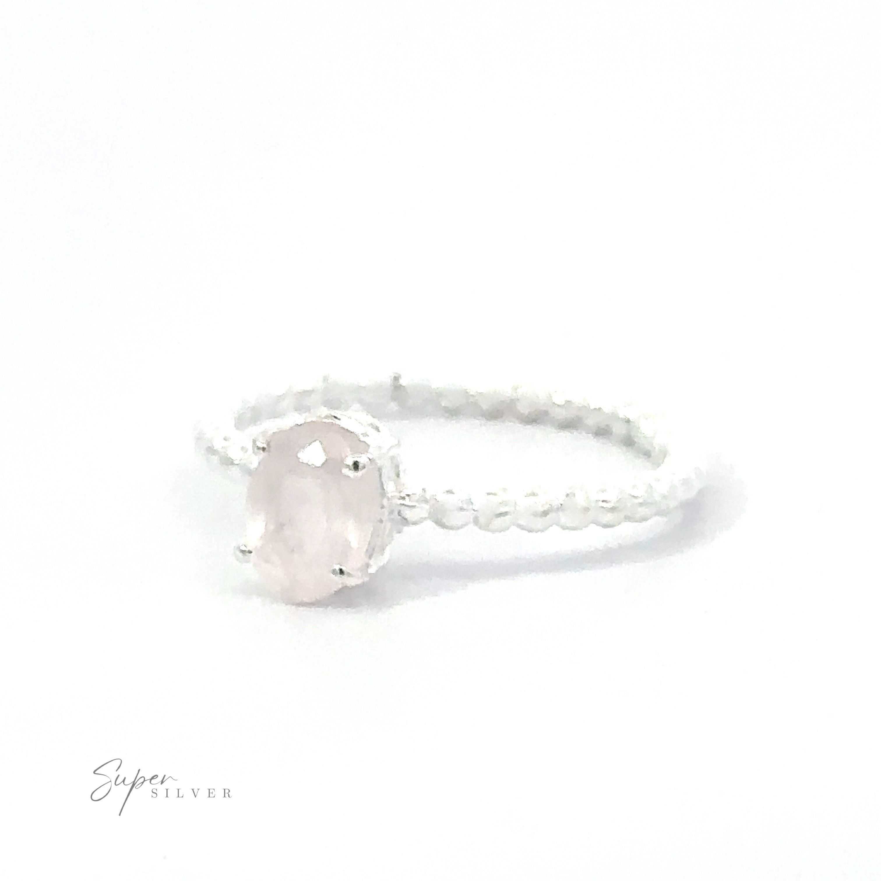 Stunning Oval Gemstone Ring with Beaded Band featuring a pink oval gemstone and a textured band.