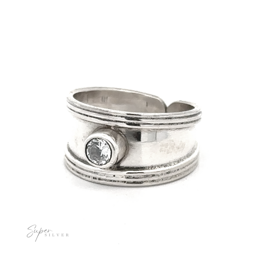 
                  
                    Adjustable Wide Cigar Band Toe Ring with Gemstone featuring a minimalist design with a single clear stone set in the center. The band is split and overlaps slightly.
                  
                