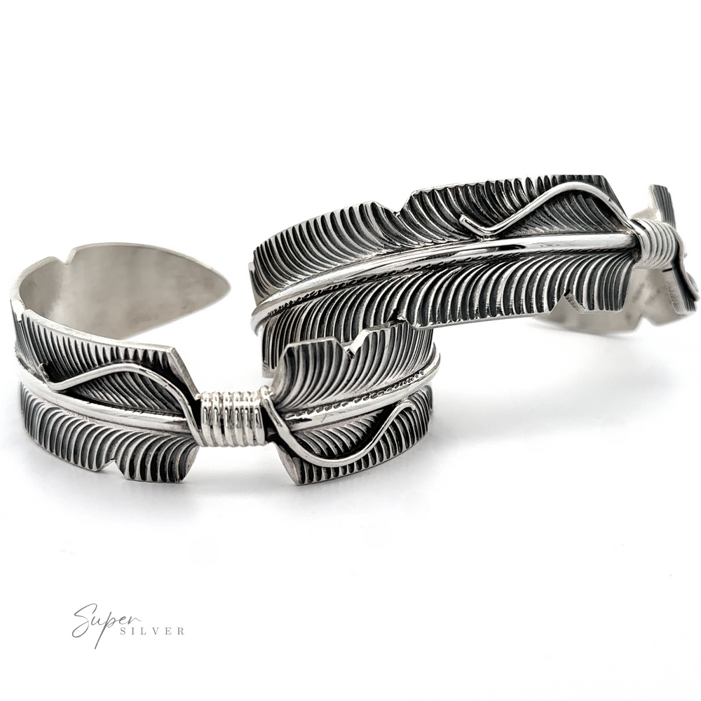 Native American Silver Feather Cuff Bracelet with detailed etching, showcased as Native American jewelry on a white background.