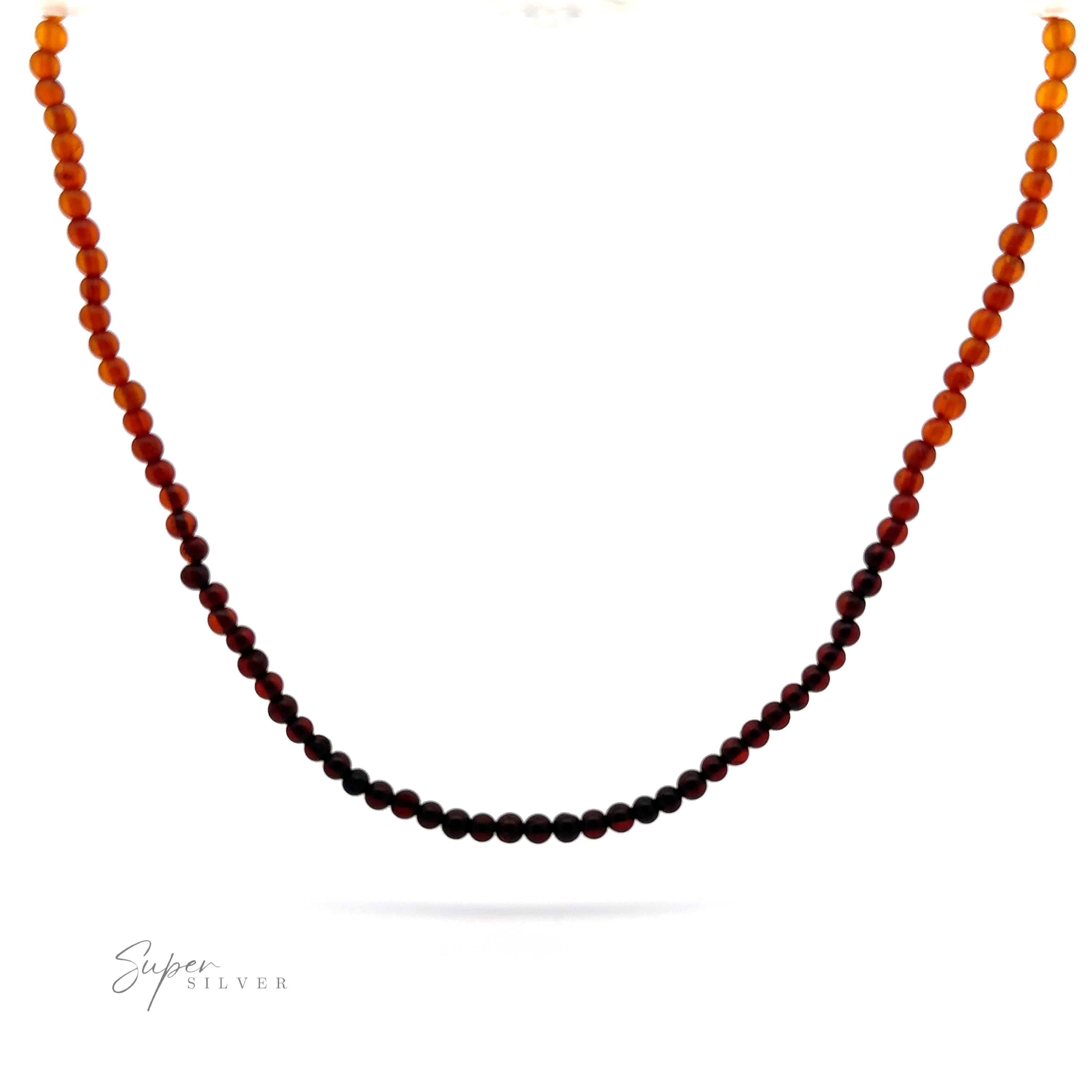 A gradient Ombre Beaded Amber Necklace transitioning from dark brown in the center to light orange at the ends, displayed on a white background with the "Super Silver" logo in the lower left corner.
