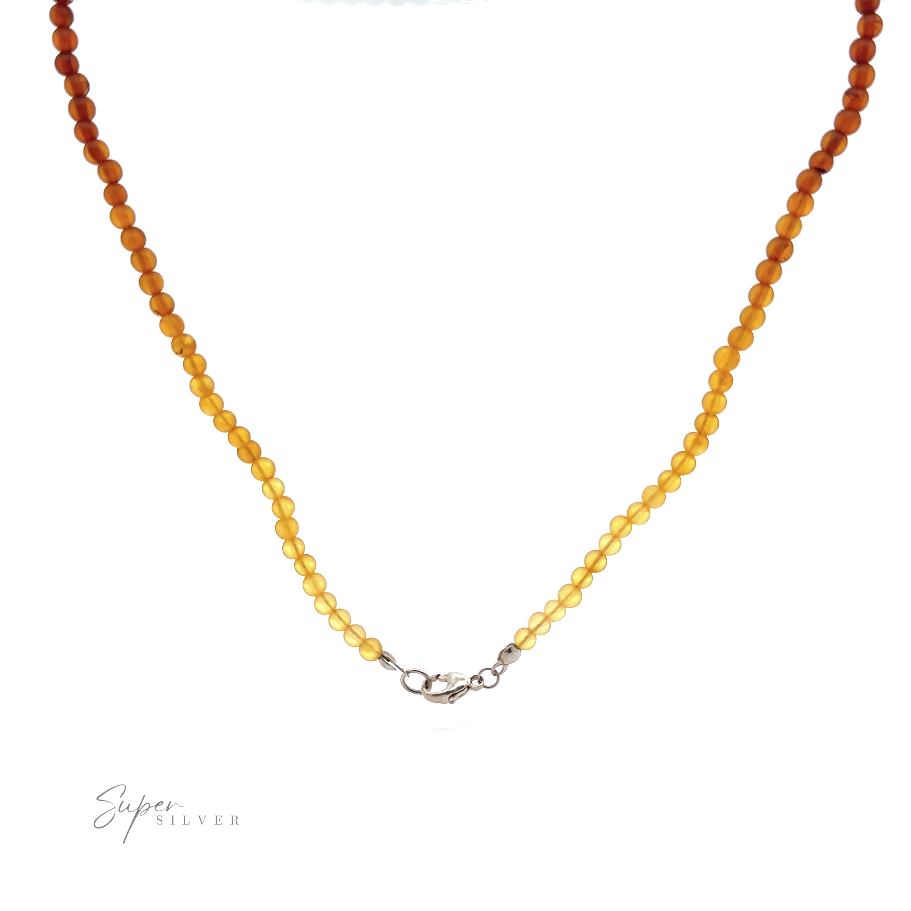 A stunning Ombre Beaded Amber Necklace with a gradient of round beads ranging from amber to yellow, featuring a sterling silver clasp. The beads are arranged in a single strand and taper in color intensity. "Super Silver" is written at the bottom left, marking this exquisite piece of sterling silver jewelry.