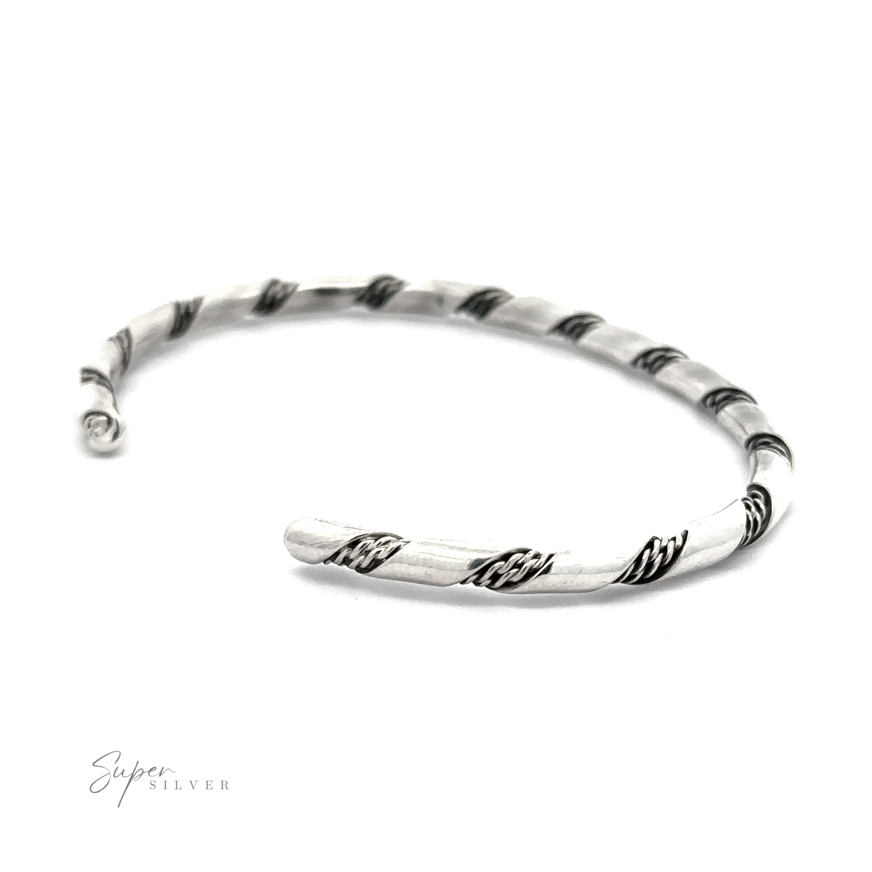 A Native American Handmade Thin Silver Twist Cuff with black rope-like accents, crafted from Sterling Silver, is laid flat on a white background. The logo "Super Silver" is visible in the bottom left corner, showcasing a delicate piece perfect for stacking.