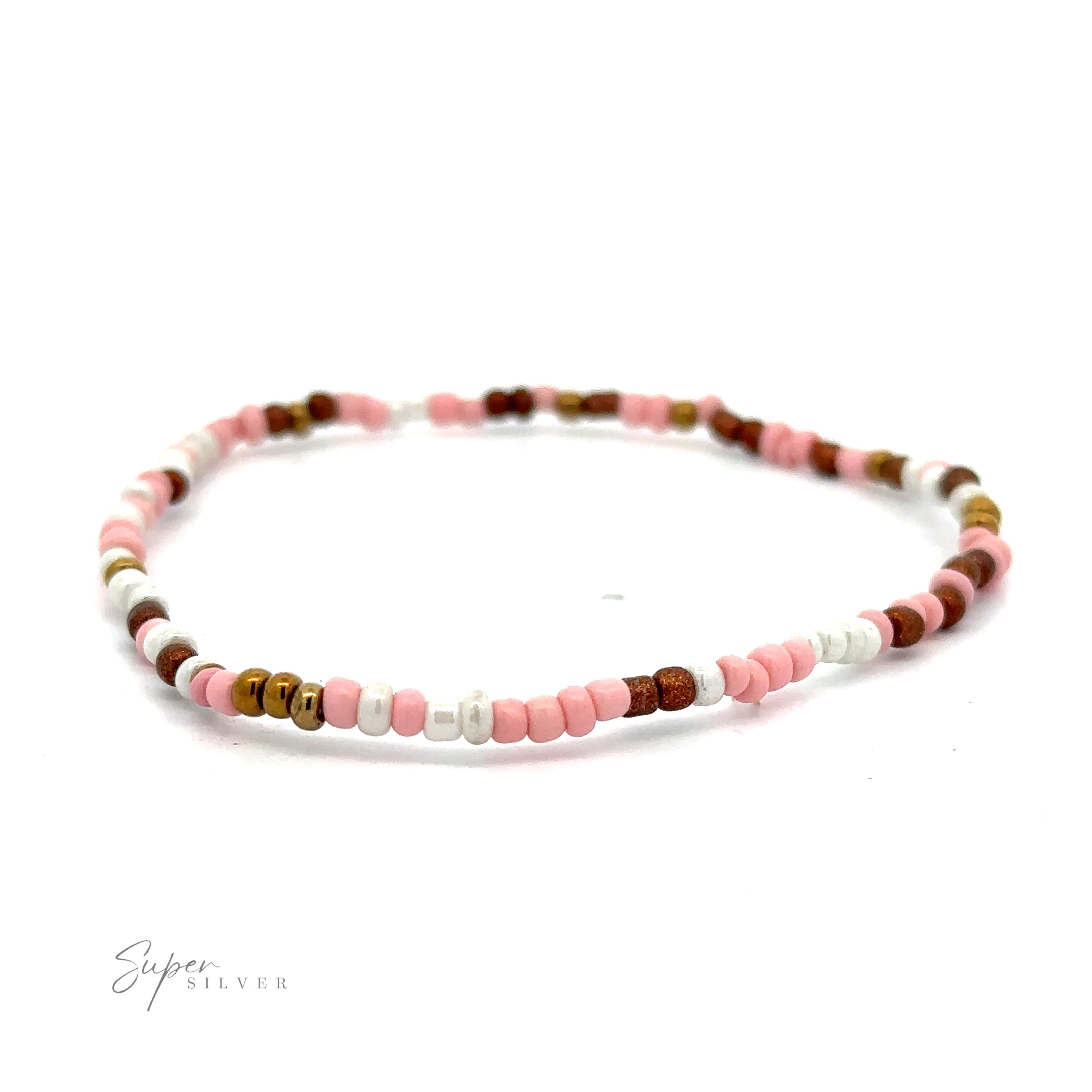 A delicate minimal bracelet featuring a simple pattern of alternating pink, white, and brown seed beads. This elegant accessory, showcasing a variety of colors, is displayed on a clean white background: the Dainty Beaded Bracelets.