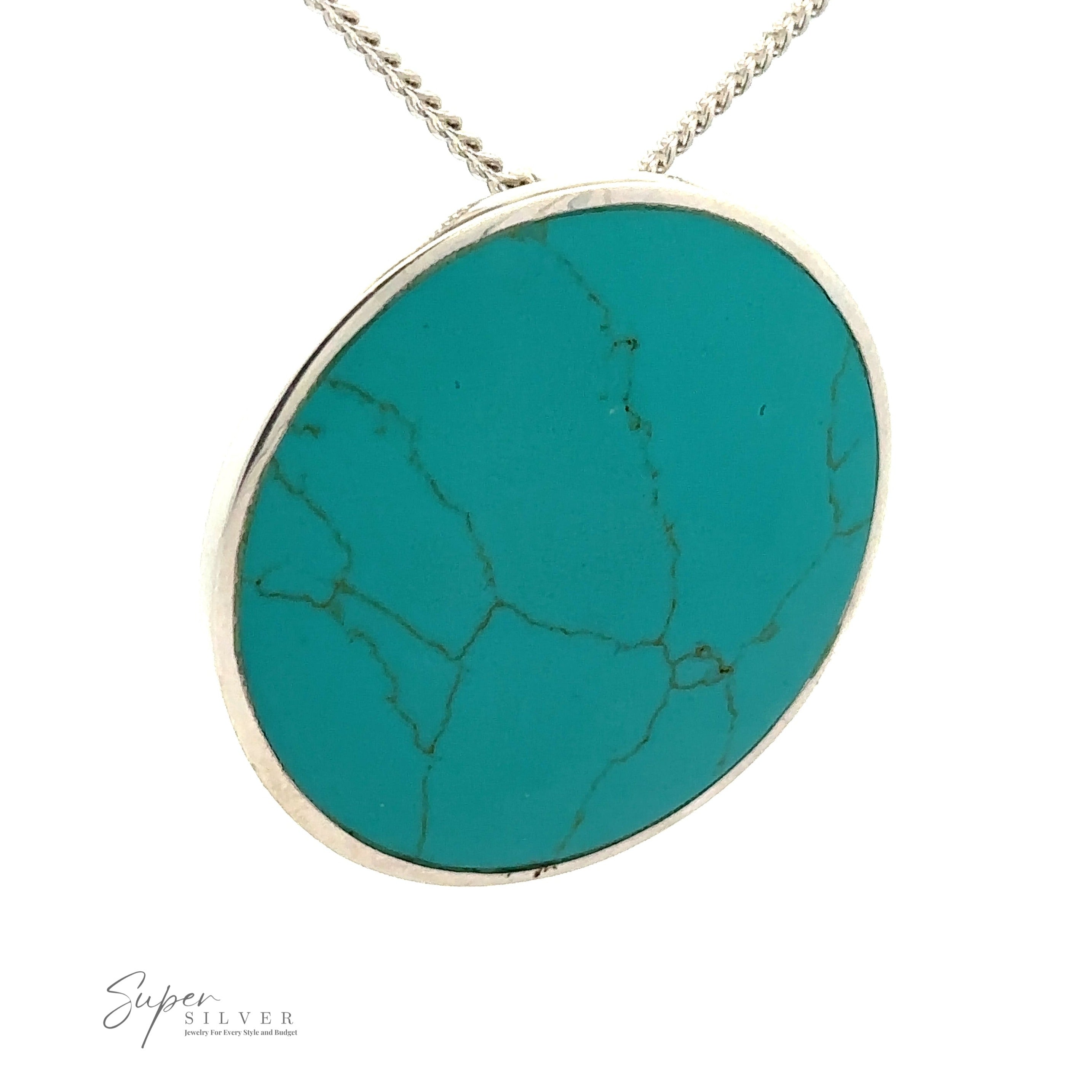 A Large Round Turquoise Pendant with visible veining set in a sterling silver bezel, hanging from a silver chain. This piece of minimalist jewelry also displays a partial logo with the text "Super Silver" in the lower left corner.