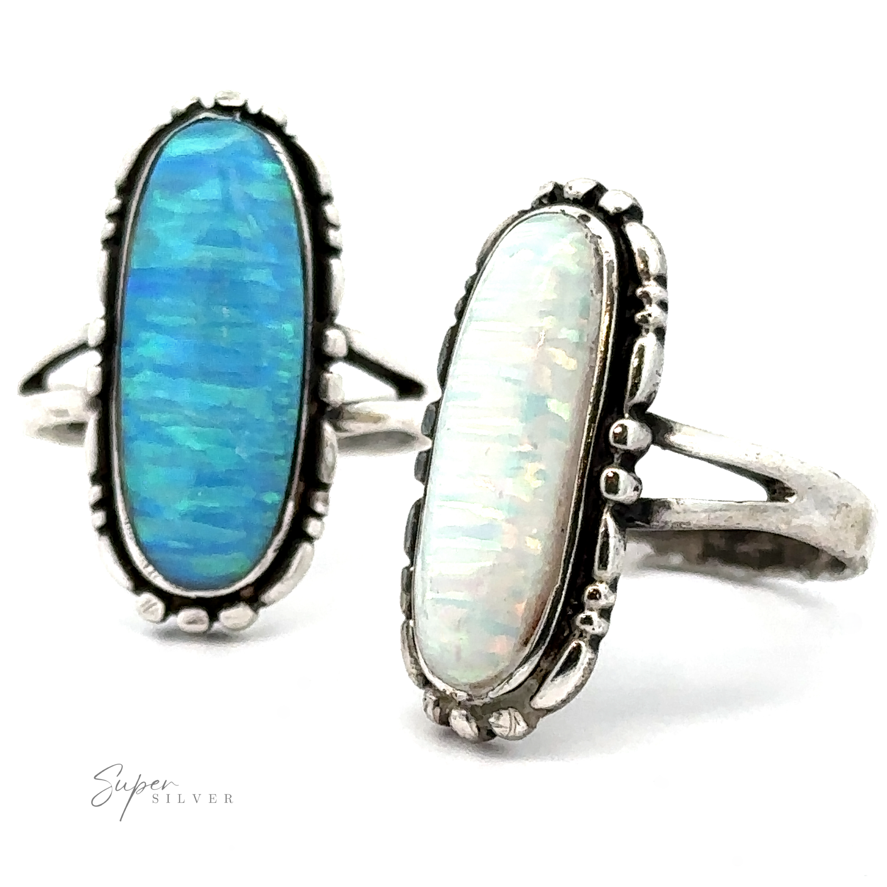Two Southwestern-styled silver rings with elongated oval stones; one features a vibrant blue stone, and the other has a light, lab-created opal. Both rings have decorative sterling silver settings. The logo "American Made Oval Opal Ring" is at the bottom left.