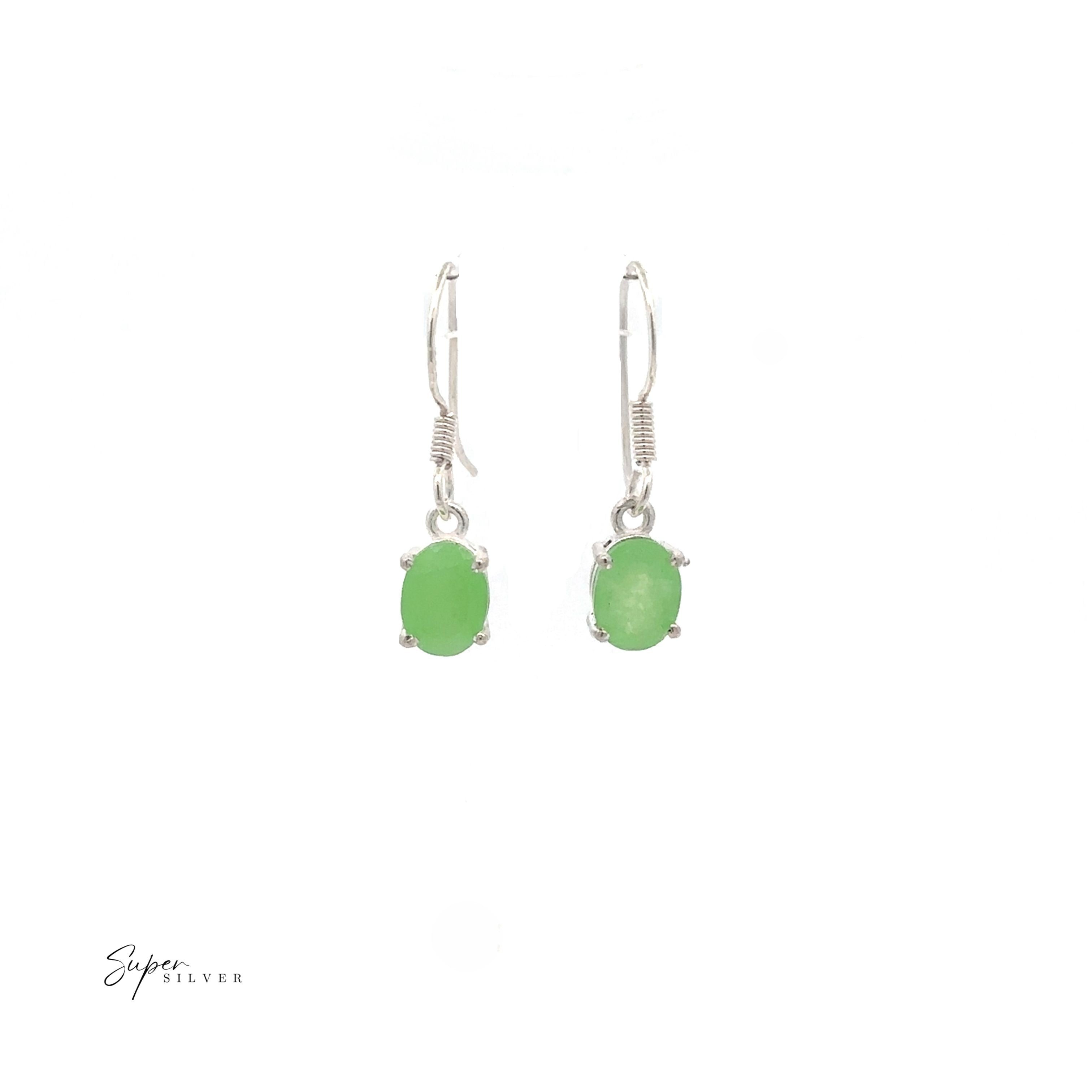 Brilliant Oval Gemstone Earrings: A pair of sterling silver drop earrings with oval green gemstones, shown on a white background.