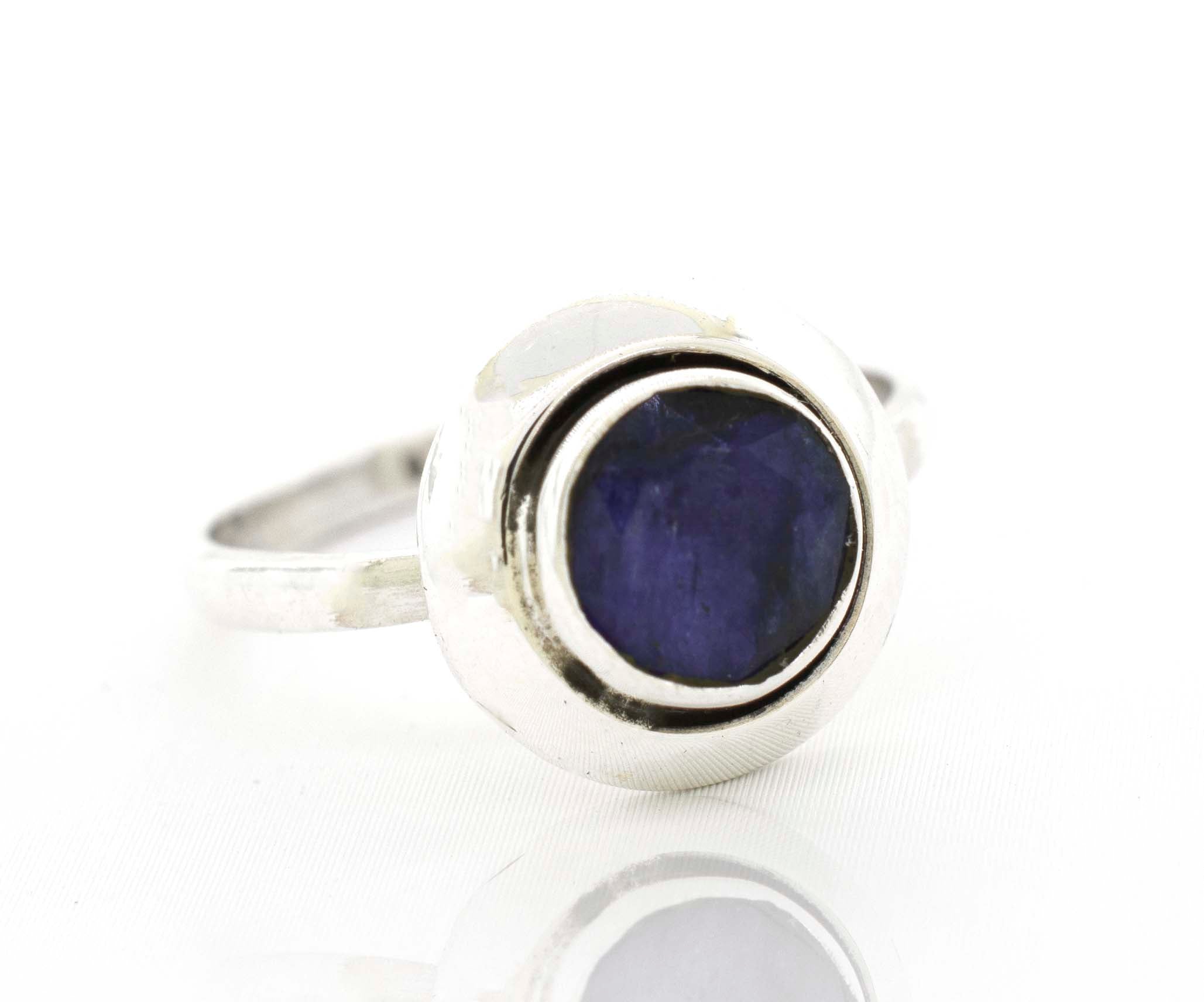 A Round Gemstone Ring With Oxidized Outline with a blue sapphire stone.