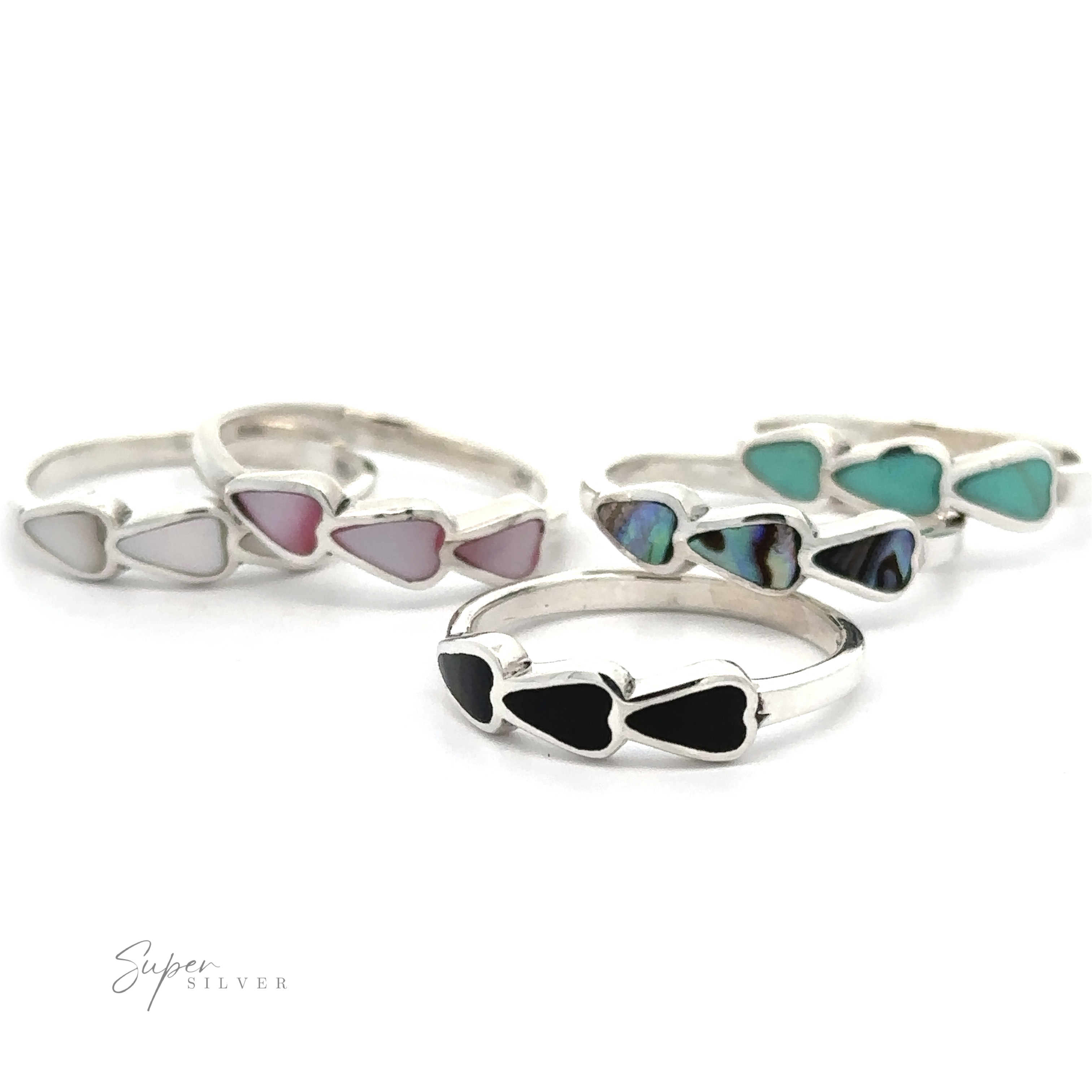 A group of Triple Heart Rings with Inlaid Stones, made from sterling silver.