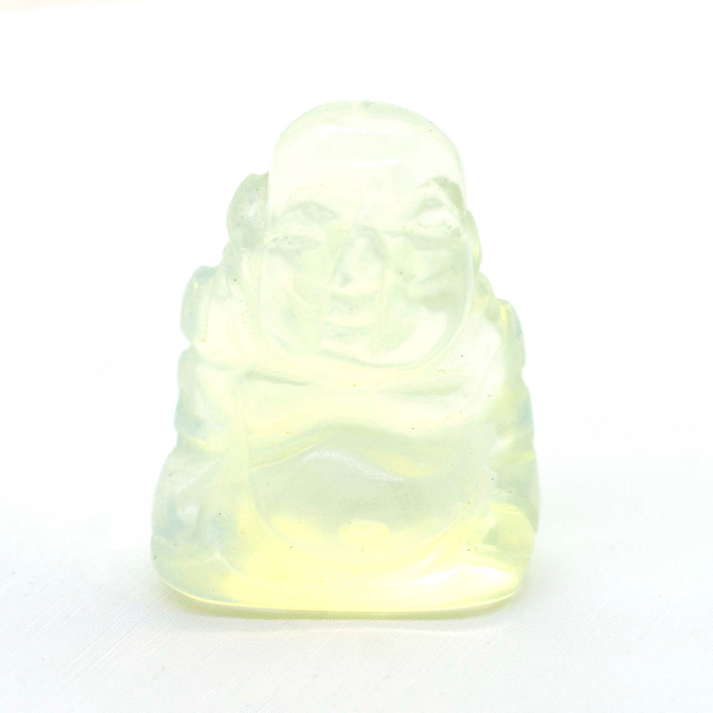 A small Laughing Buddha Gemstone Figure sitting on a white surface.