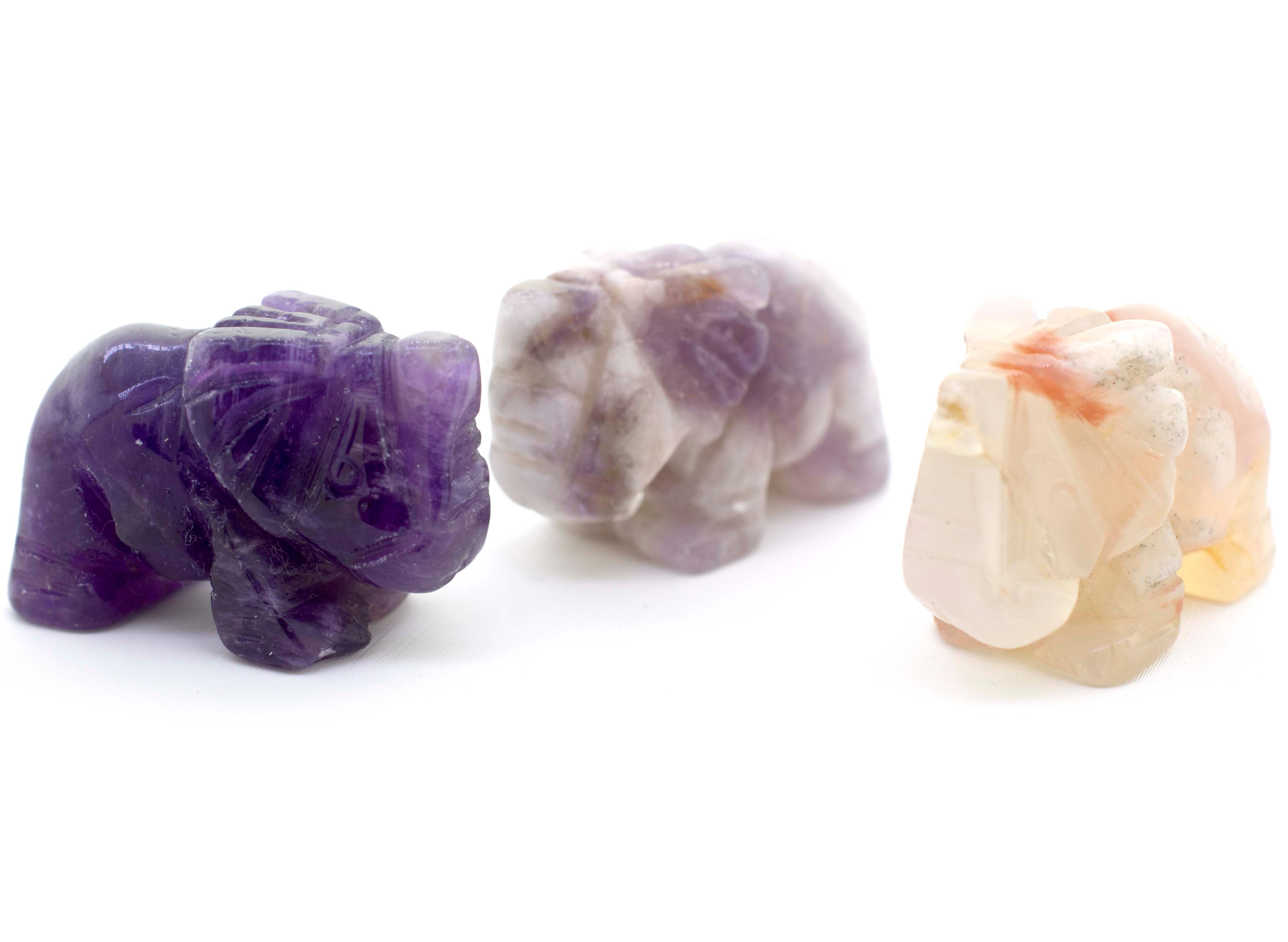 Three Elephant Carved Gemstone Figures in brown and purple colors.