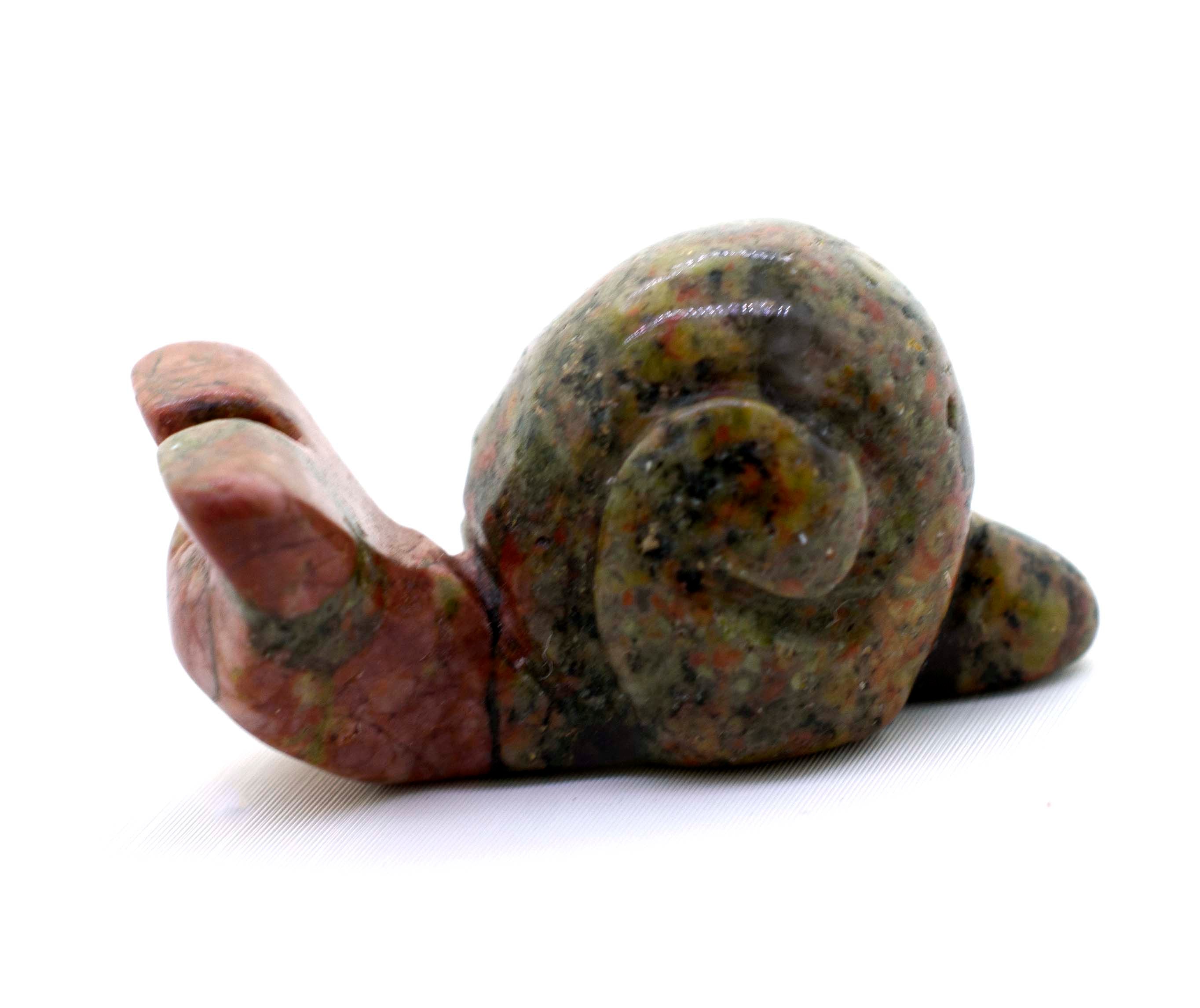 A Snail Carved Gemstone Figure on a white background.