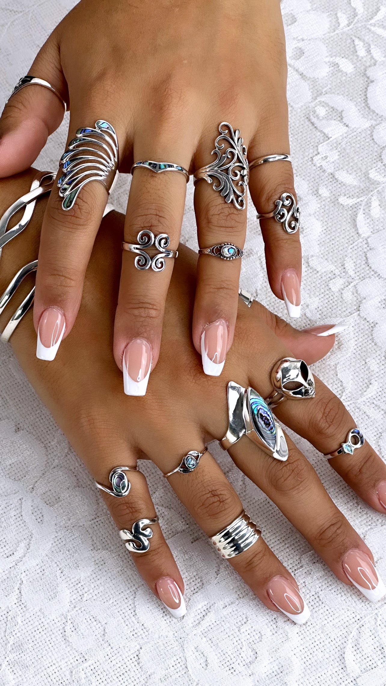 A woman's hands adorned with captivating rings, including the Beautiful Inlay Stone Wing Fan Ring.