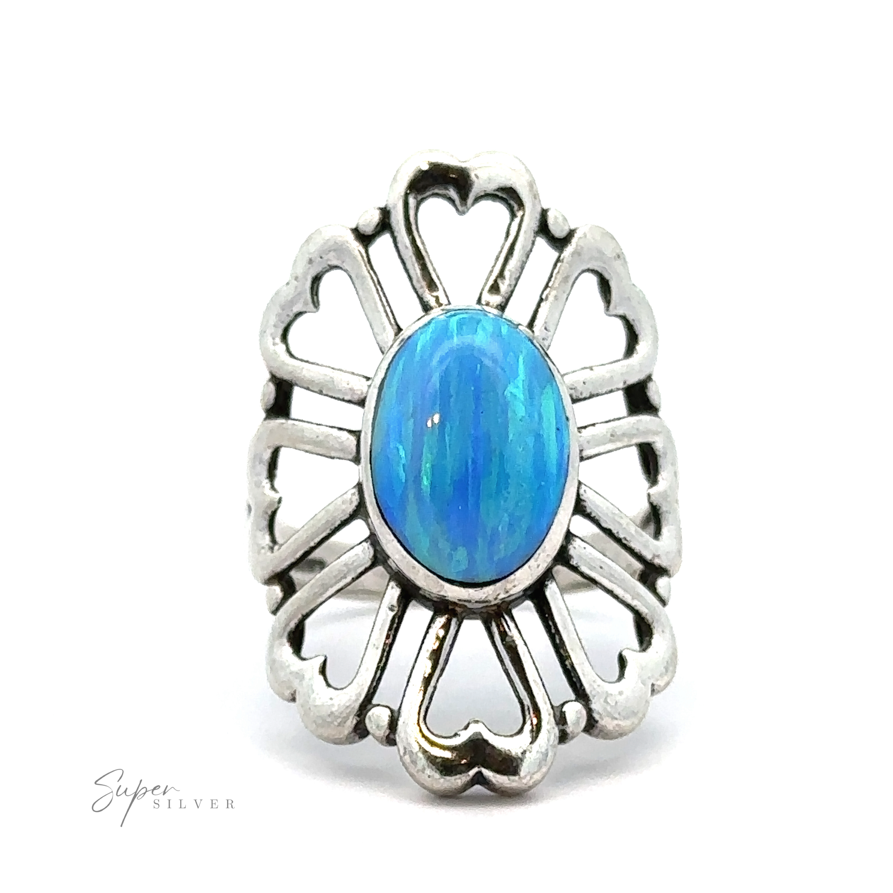 An American Made Opal Flower Ring with Heart Shaped Petals featuring a large oval blue gemstone at its center, surrounded by intricate heart-shaped cut-out designs. The words "Handcrafted in America" are visible in the lower left corner.