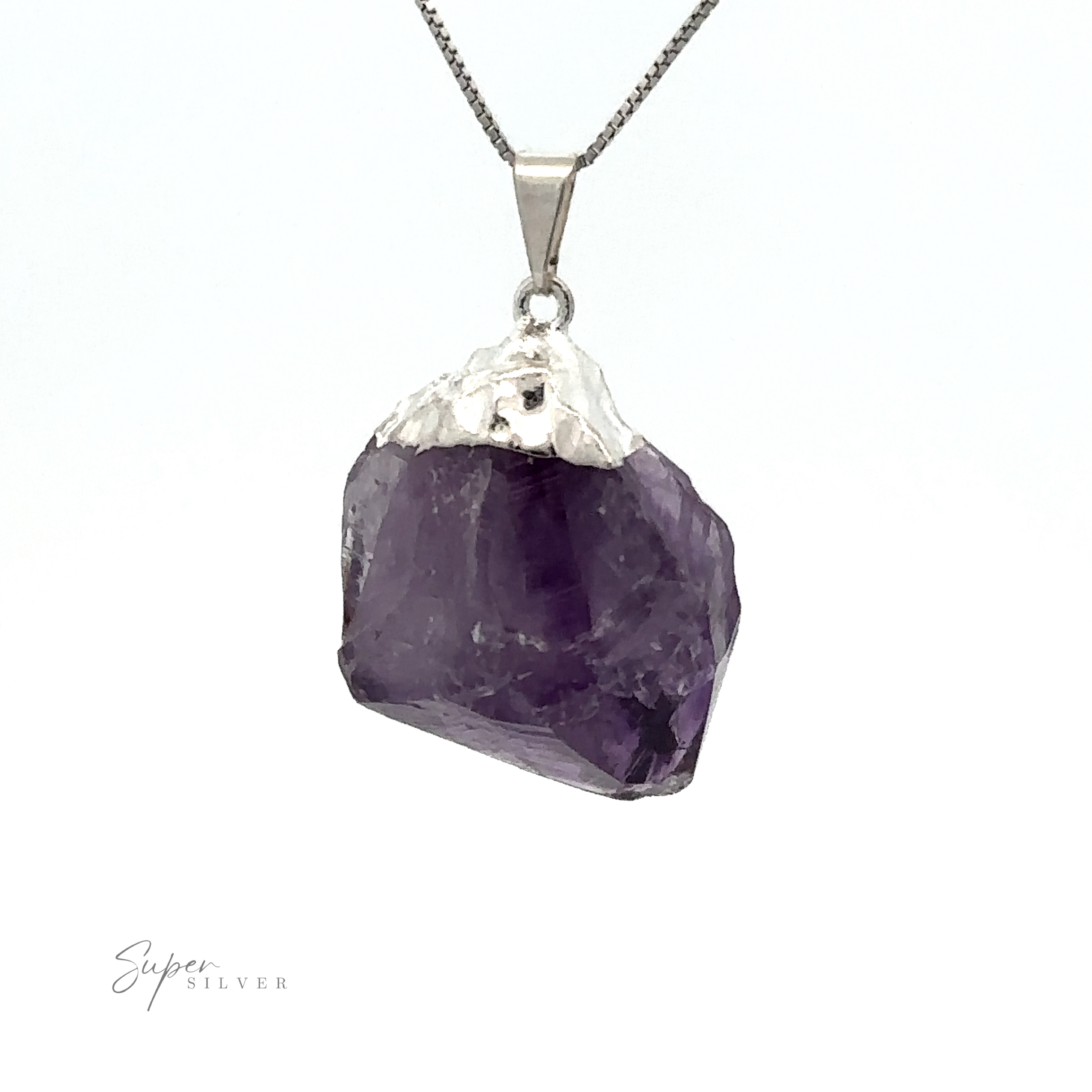 A silver necklace features a Raw Crystal Pendant With Silver Cap on a delicate chain against a white background.