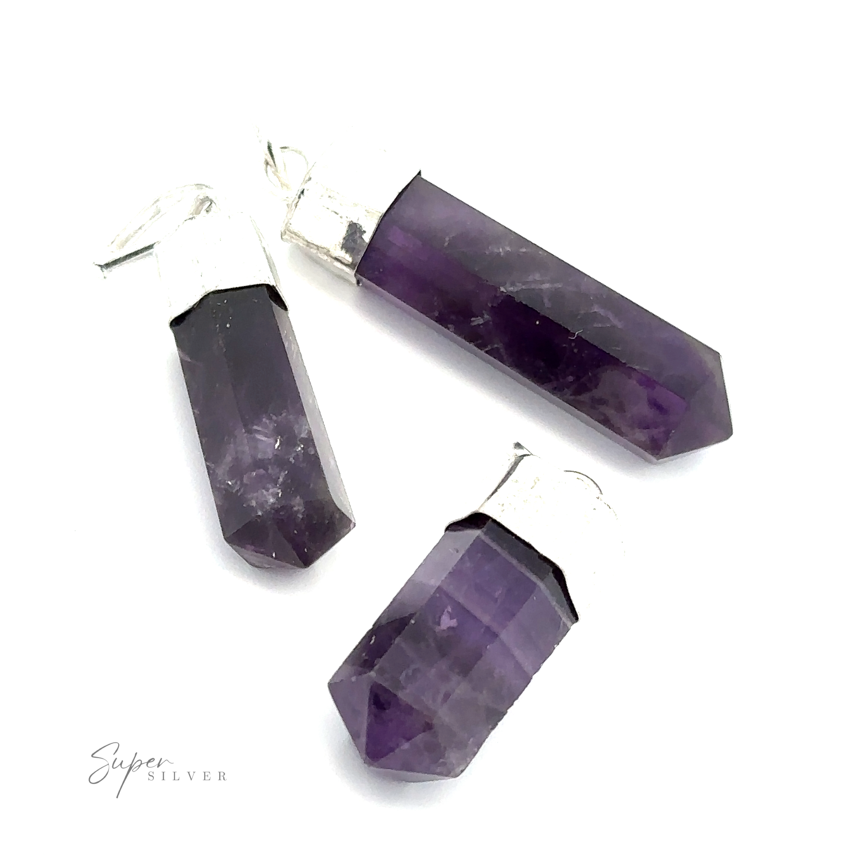 Three Simple Gemstone Point Pendants with silver caps arranged on a white background. Text "Super Silver" is visible in the lower left corner, featuring an earthy design that highlights their natural beauty.