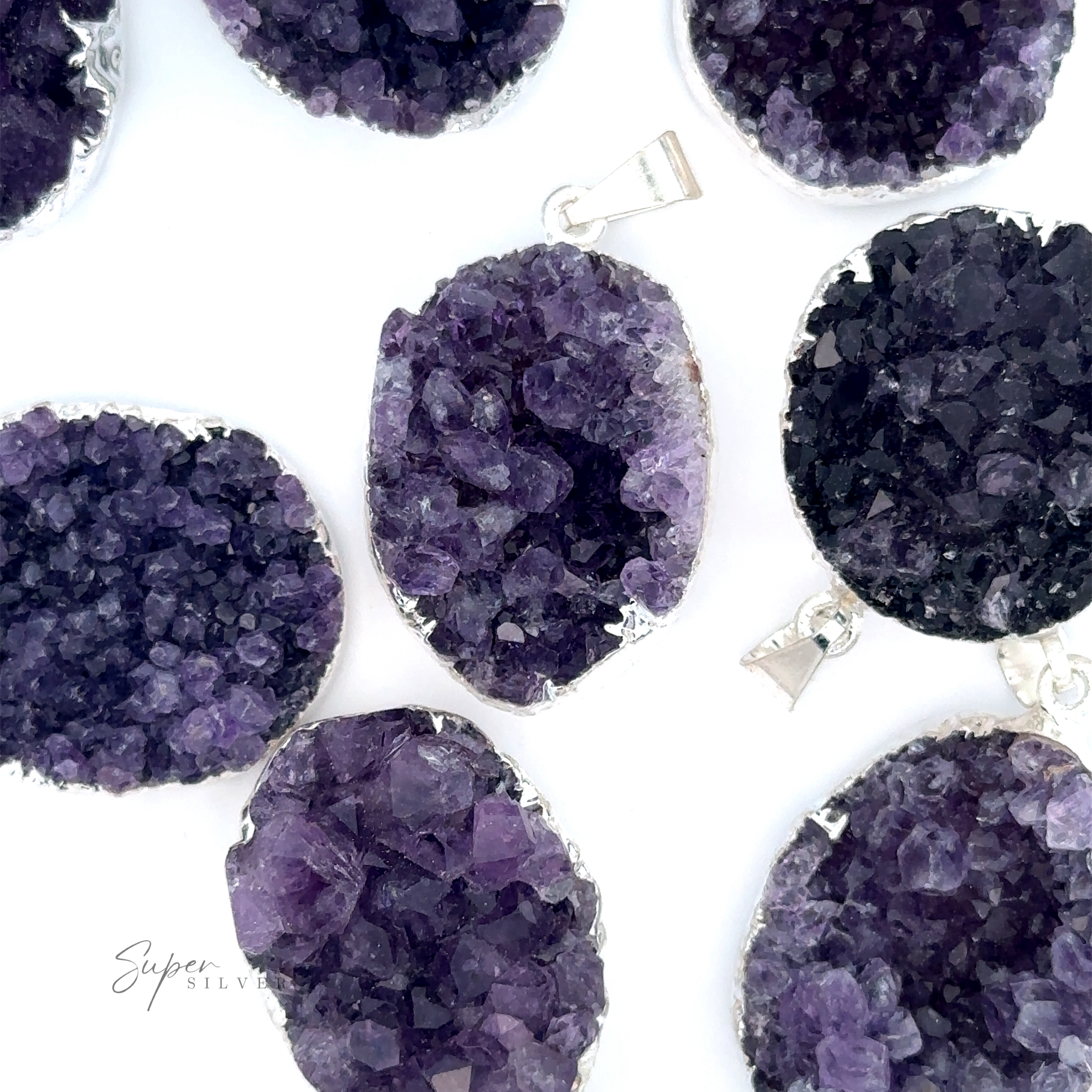 Amethyst Geode Pendants with silver-plated edges are displayed on a white background in an oval shape.