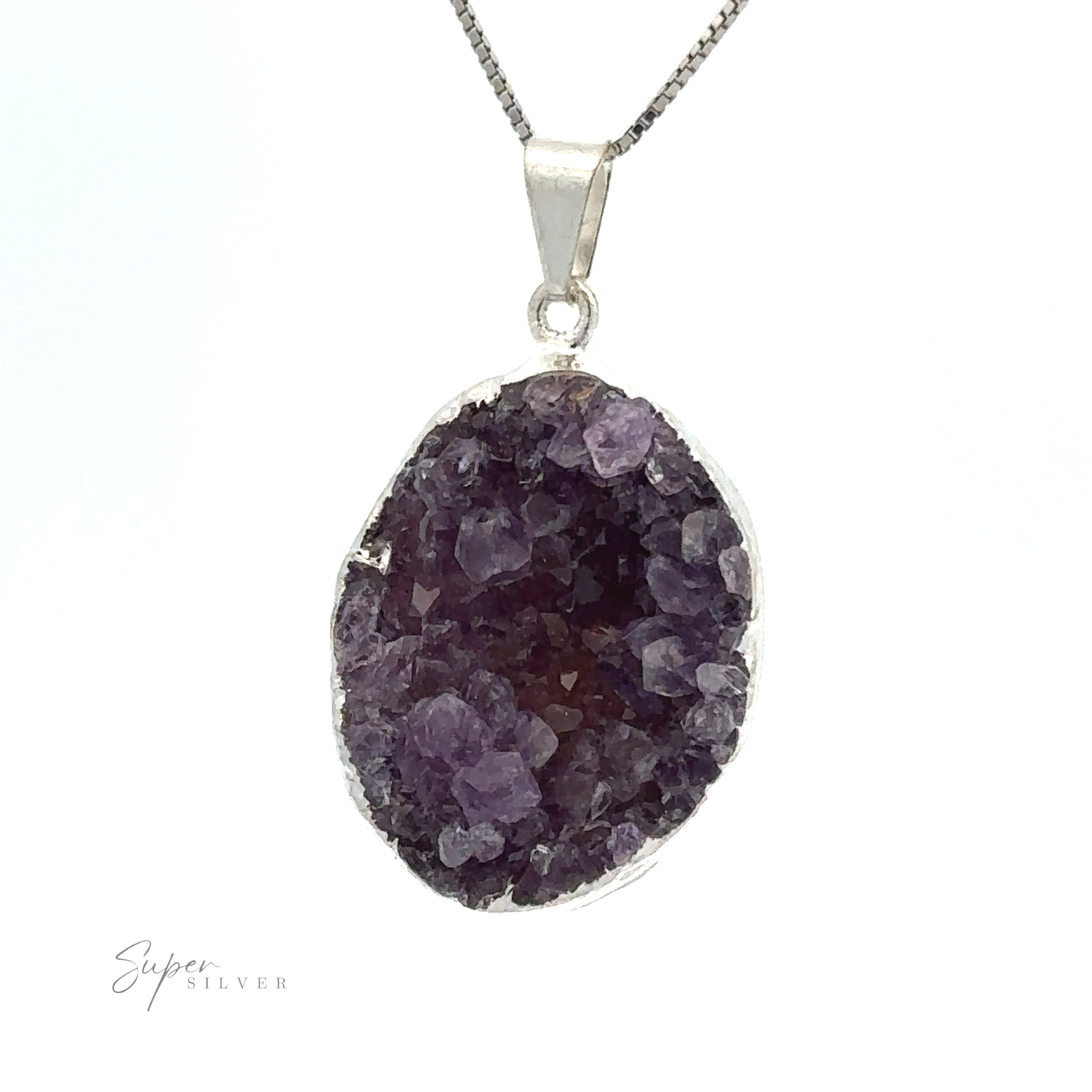 Close-up of an Amethyst Geode Pendant featuring a purple crystal on a silver chain against a white background. Encased in silver-plated casing, the Amethyst Geode Pendant has rough, faceted edges, and the inscription "Super Silver" is visible at the bottom left.