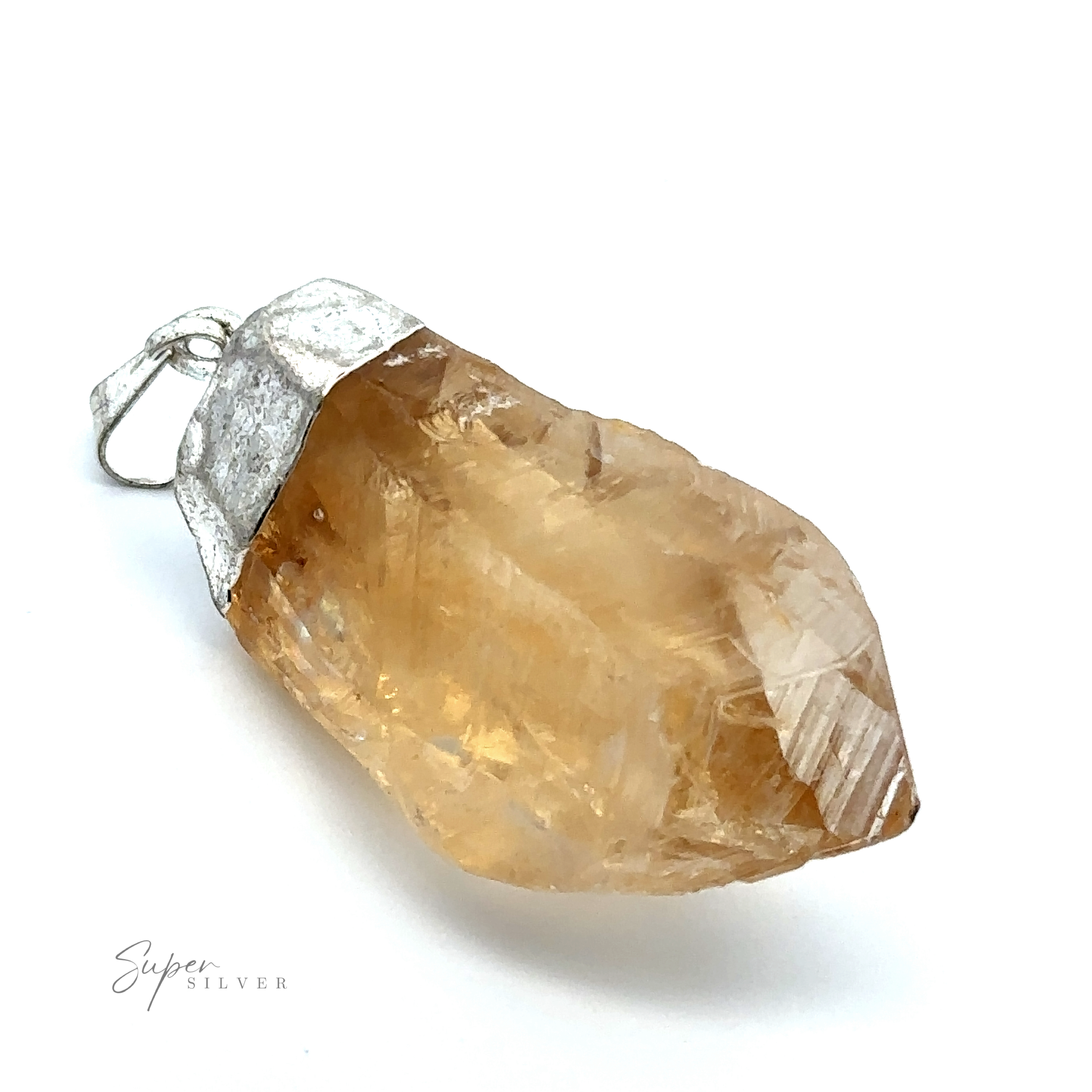 A Raw Crystal Pendant With Silver Cap featuring a yellowish-brown raw crystal encased in a silver setting with a loop for attaching to a necklace.