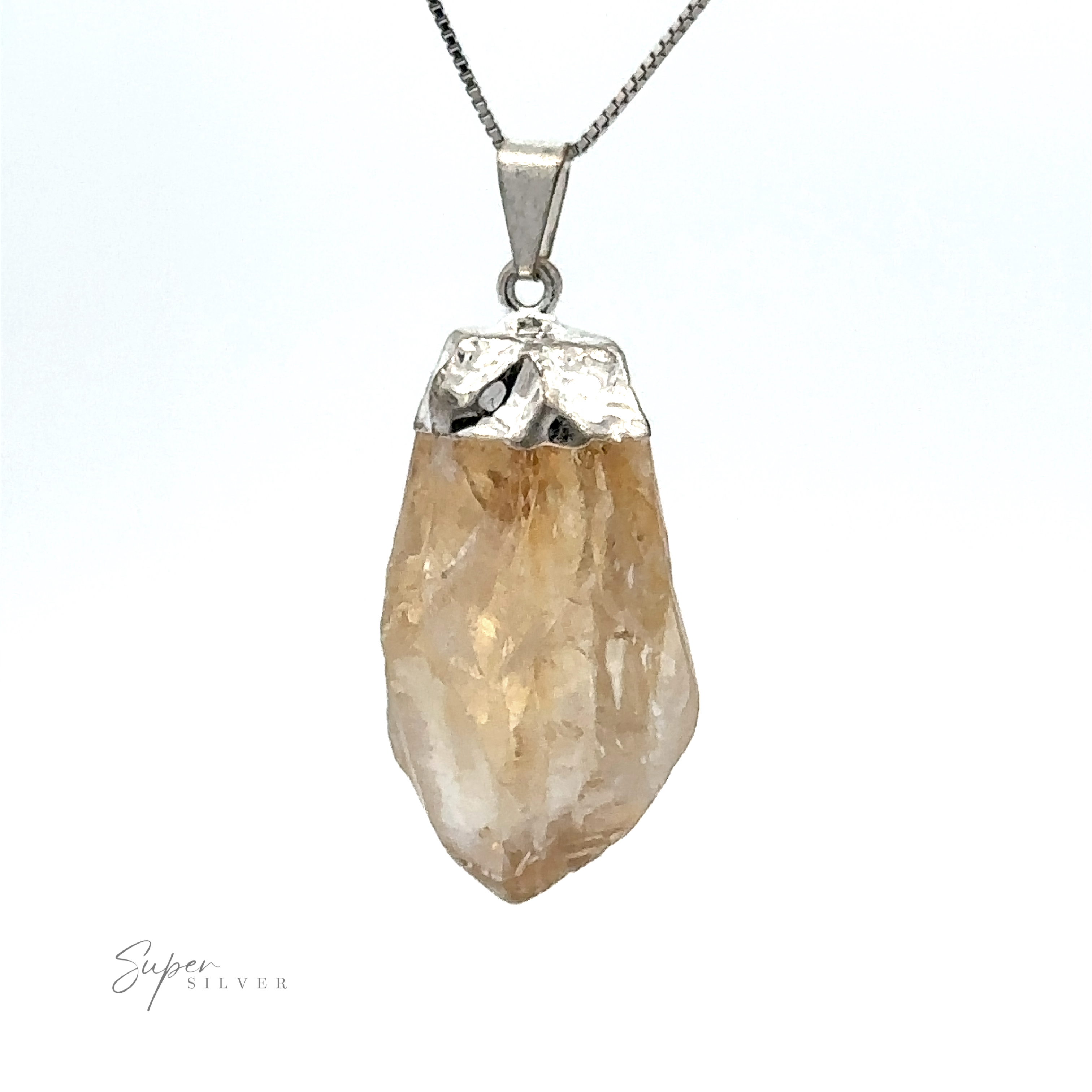 A Raw Crystal Pendant With Silver Cap featuring a raw, brownish-yellow crystal encased in a silver setting, hanging from a silver chain.