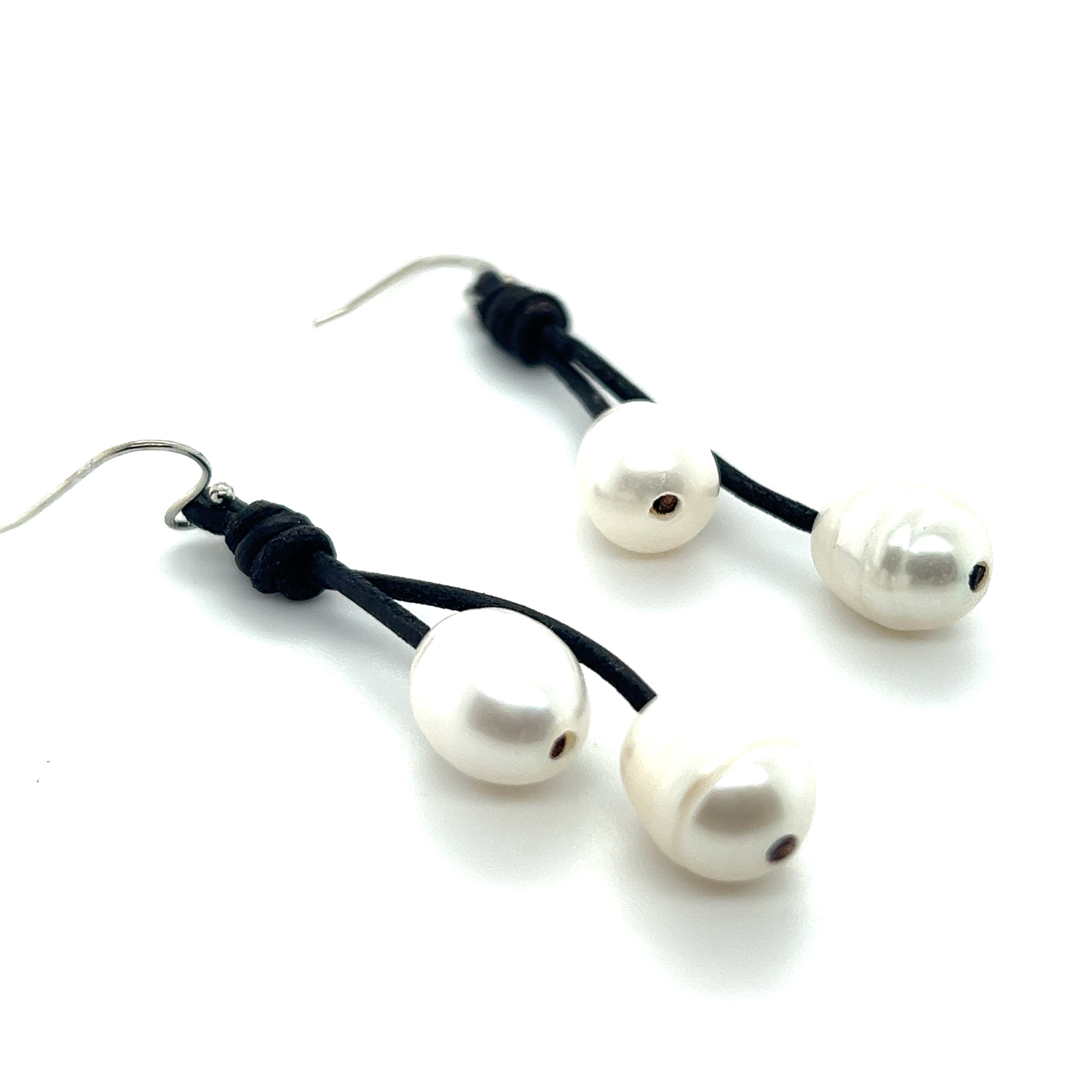 A pair of Super Silver Leather Cord and Pearl Earrings with a leather loop.