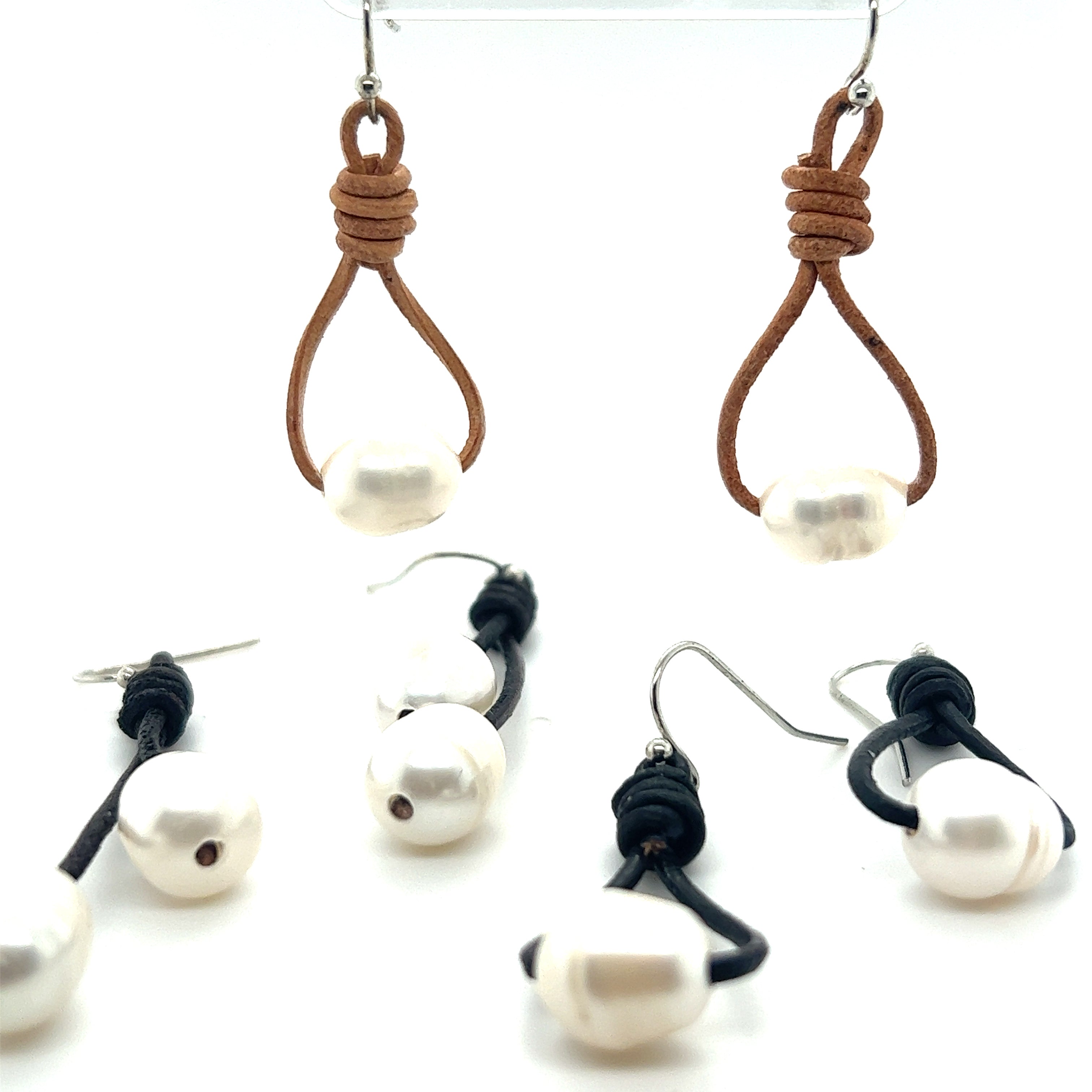 A pair of Super Silver Leather Cord and Pearl Earrings for a laid-back style.