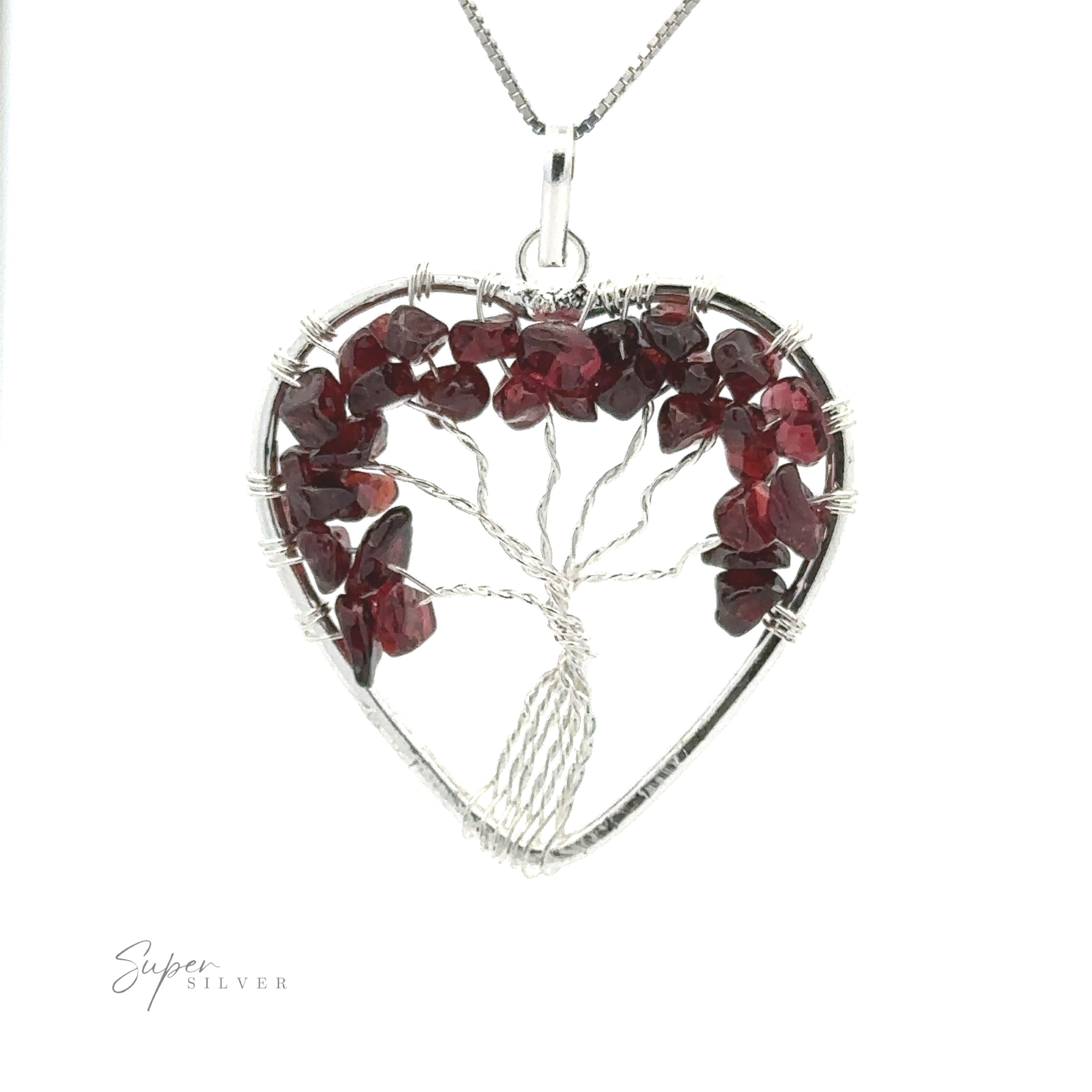 A Heart Shaped Tree of Life Pendant made from silver wire and red gemstone chips is shown on a silver necklace chain against a white background.