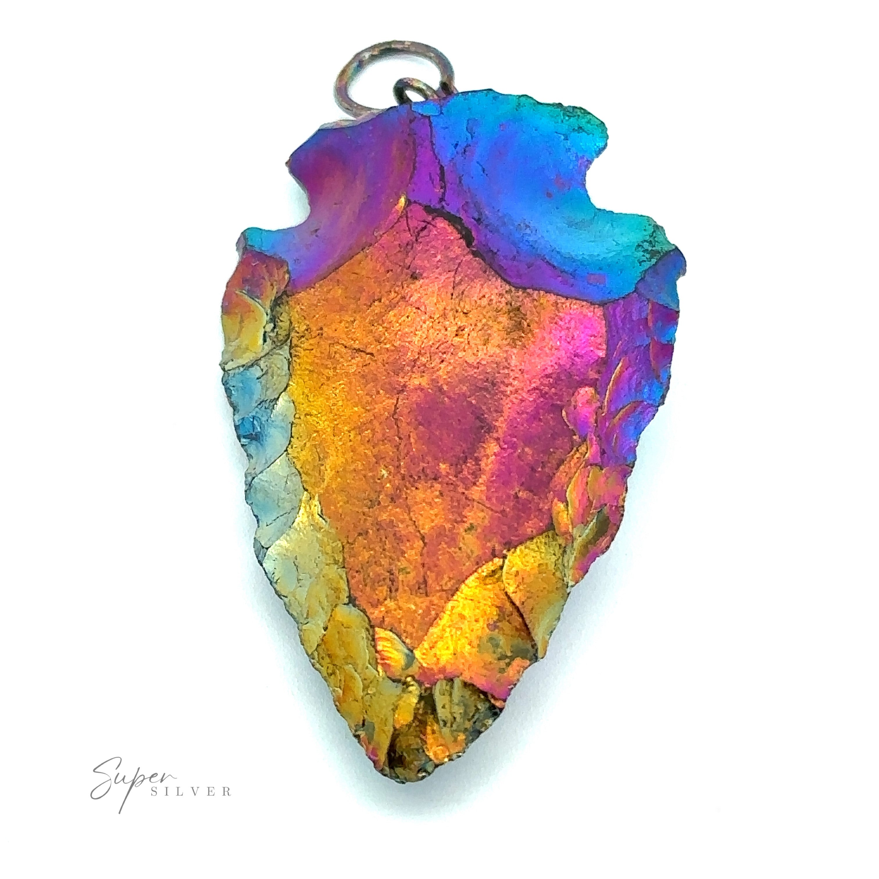 A vibrant Rainbow Hematite Arrowhead Pendant with shades of blue, purple, and gold, featuring a small ring at the top for attachment. Crafted with mixed metals, it proudly displays the brand "Super Silver" on the bottom left.