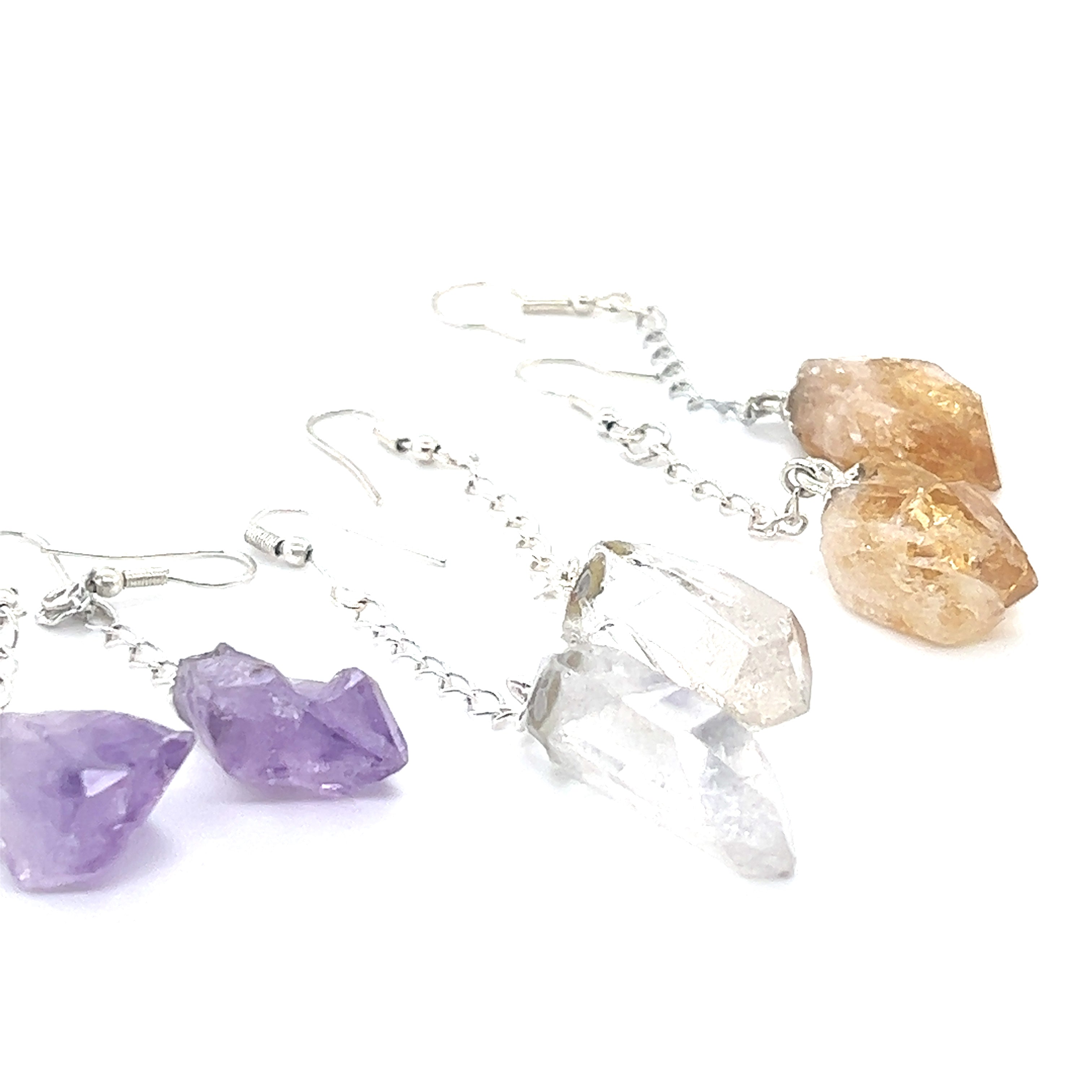 A pair of Long Crystal Earrings With Chain adorned with raw, multicolored crystals, perfect for the bohemian earth lover.