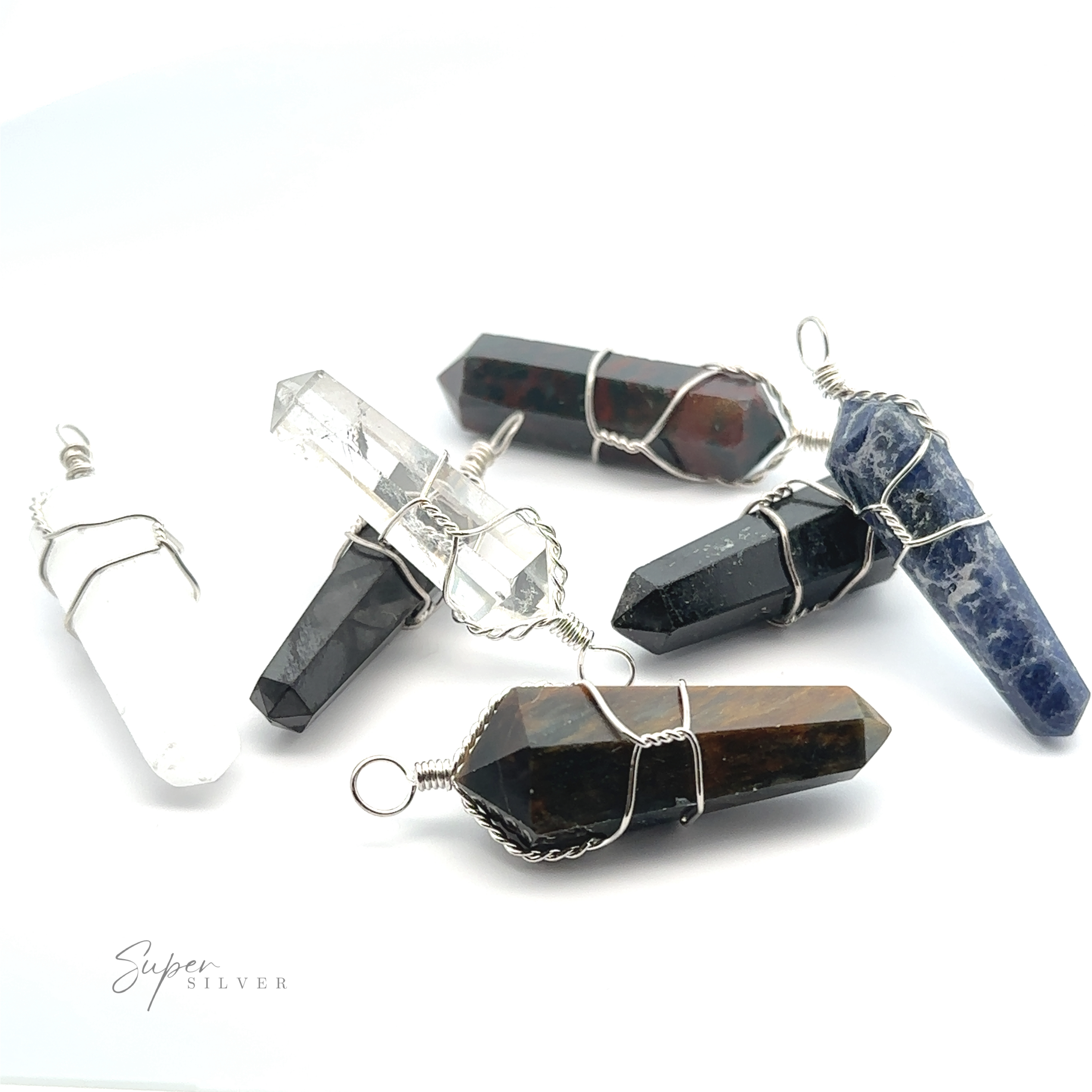 Six Wire Wrapped Stone Pendants with wire wrapping, including clear quartz, black, blue, and multicolored stones like bloodstone, are arranged on a white background.