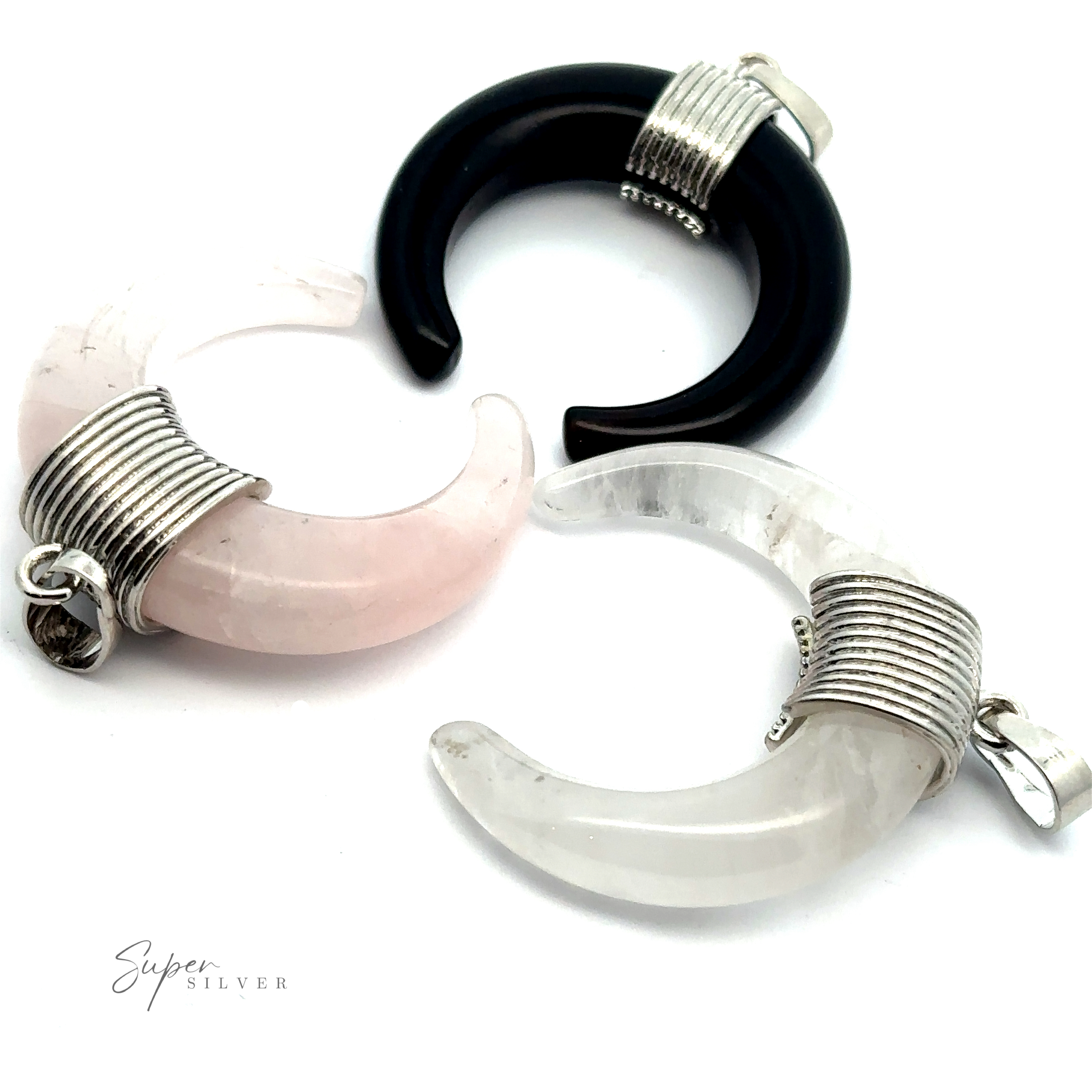 Three Naja Stone Pendants, one black, one pink, and one white, each wrapped with mixed metals of silver wire and attached to a small loop for chains or cords.