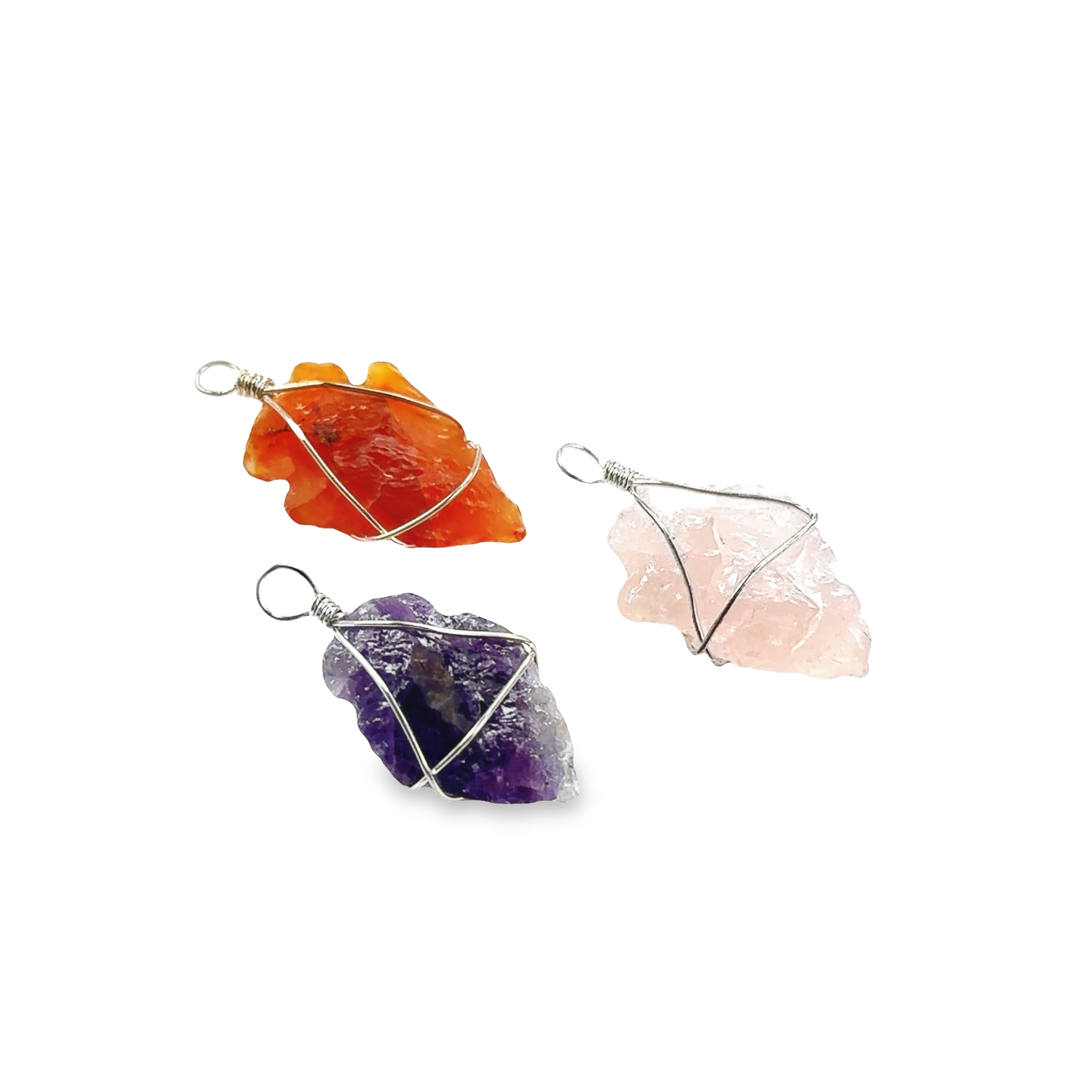 Three Super Silver Wire Wrapped Stone Arrowhead Pendants set in stylish pendants on a white background, each holding their own symbolism.