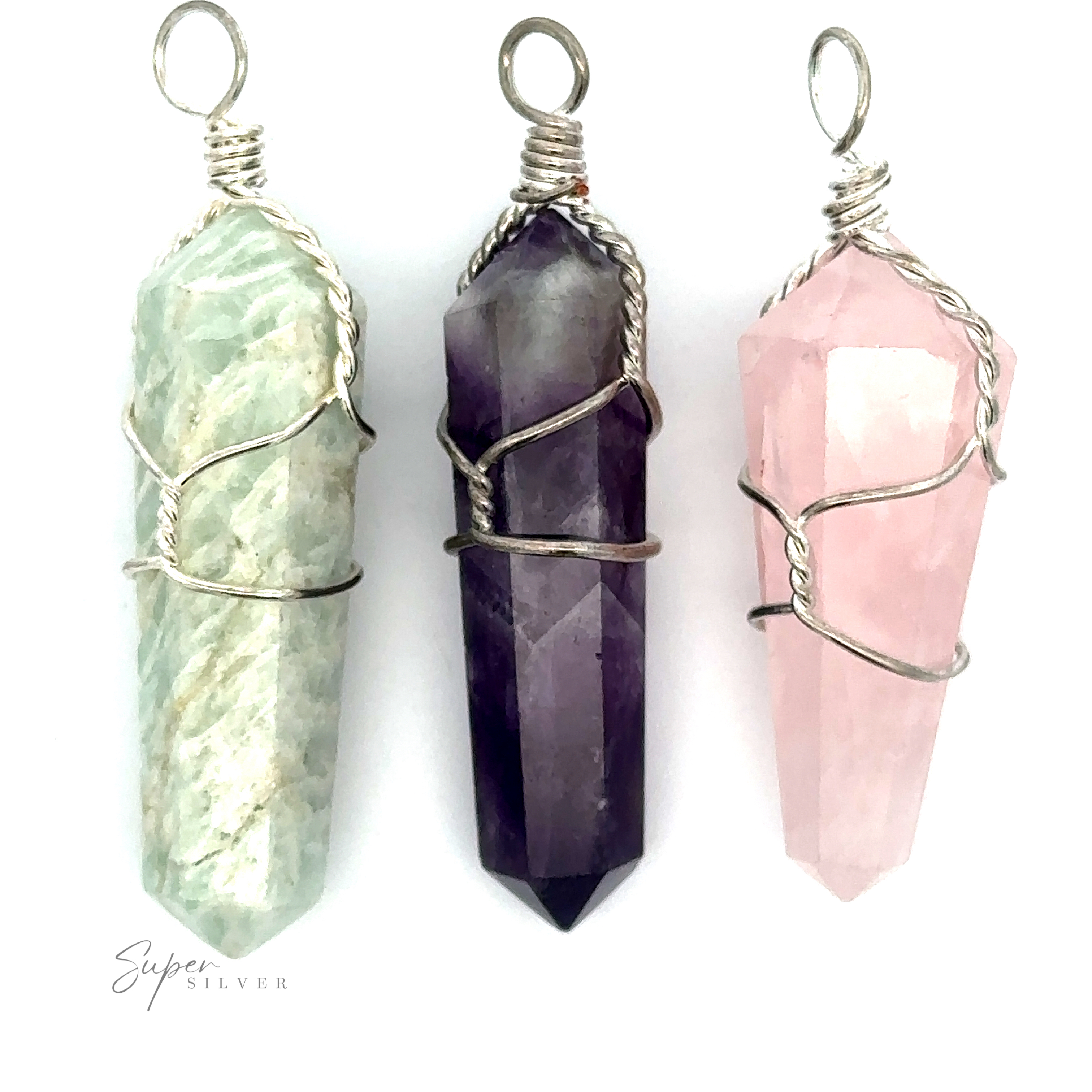 Three Wire-Wrapped Stone Pendants: a light green genuine stone pendant on the left, a dark purple obelisk-shaped gemstone in the middle, and a pink crystal on the right.