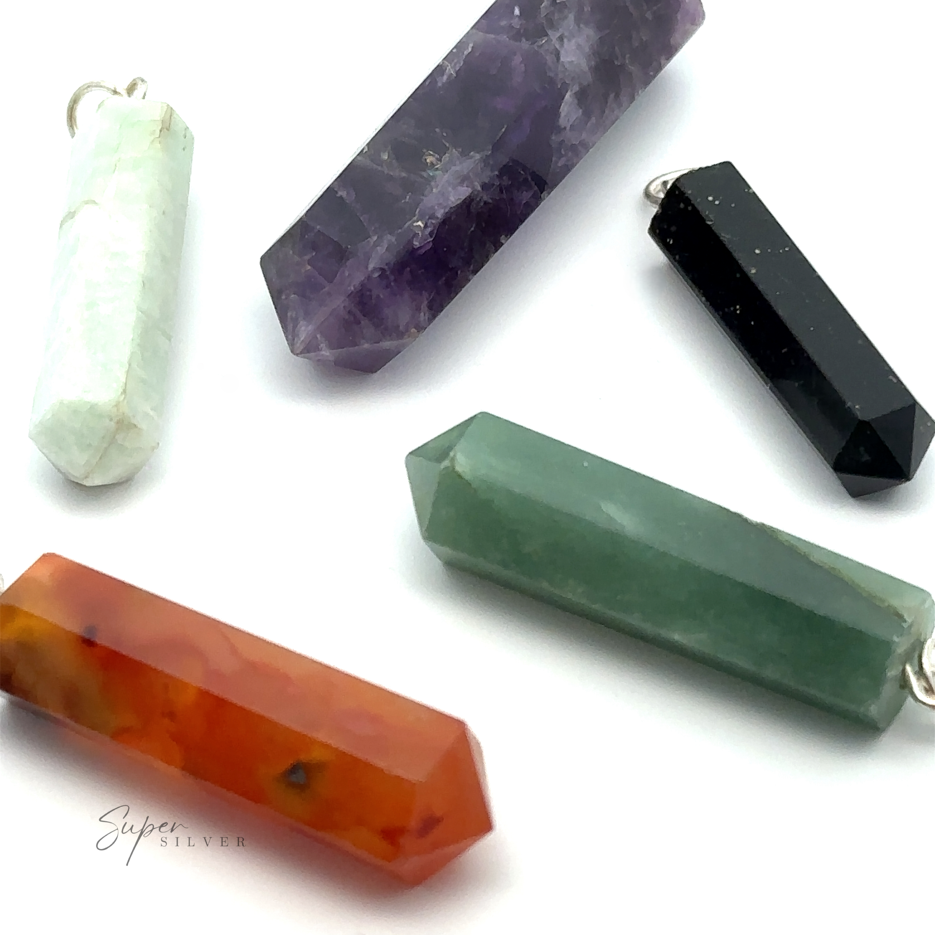 Five Raw Stone Obelisk Pendants, featuring amethyst, black onyx, green aventurine, white jade, and carnelian stones, arranged on a white surface.