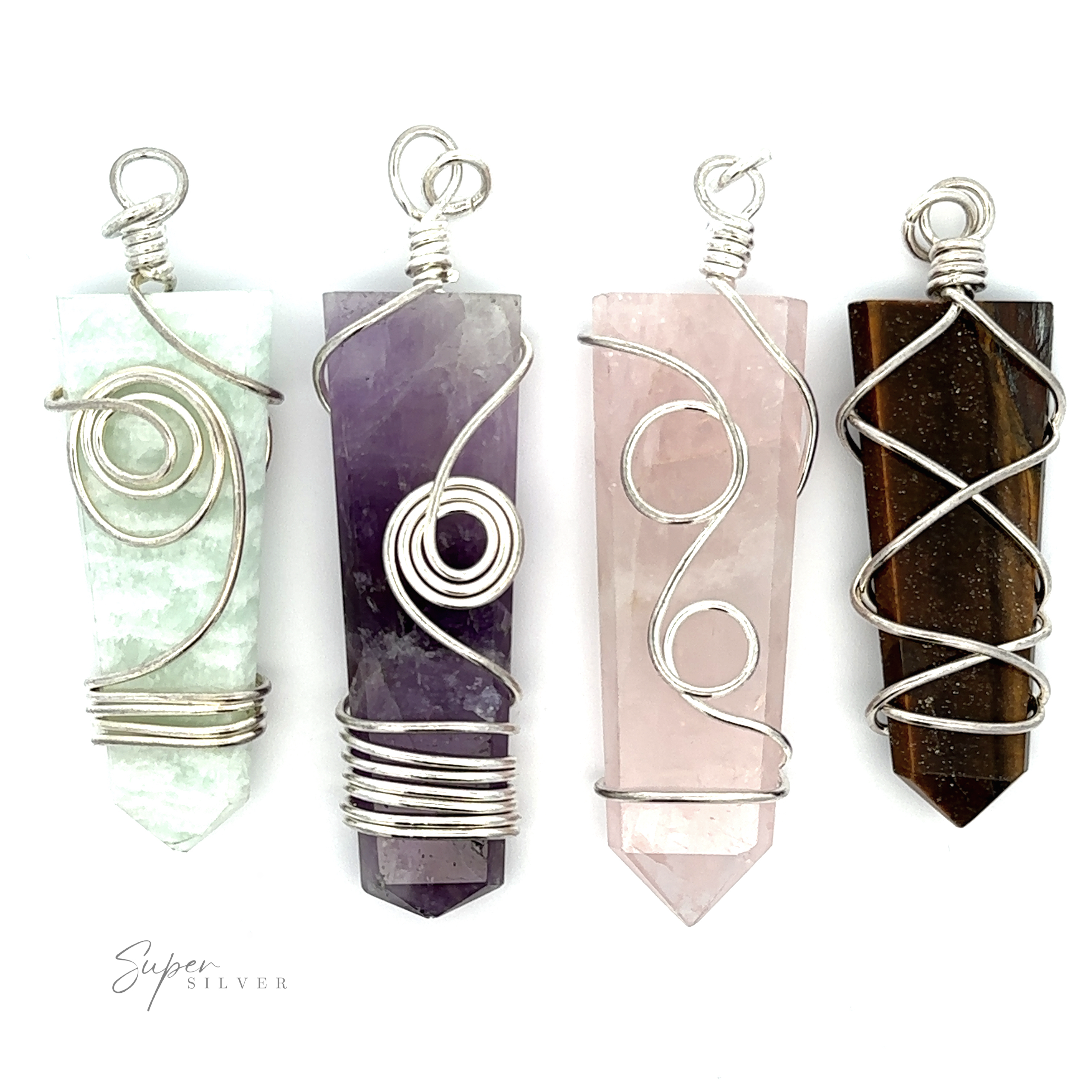 Four Stone Slab Pendants with Wire Wrapping are displayed side by side on a white background, featuring green, purple, pink, and brown stones. These stunning gemstone pendants showcase the artistry of wire wrapped jewelry and mixed metals to create unique pieces.