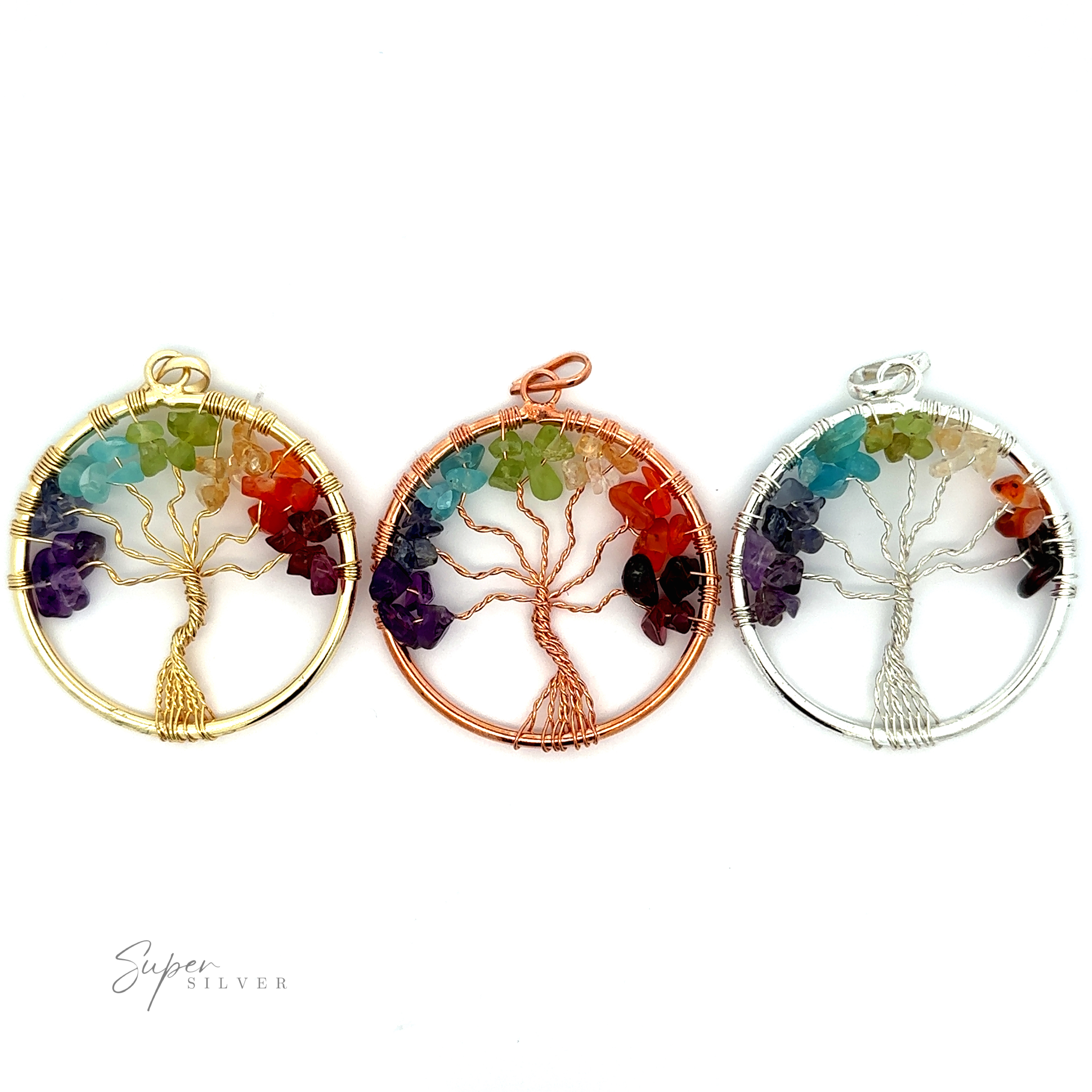 Three circular Wire-Wrapped Chakra Tree of Life Pendants featuring exquisite wire-wrapped tree designs with multicolored chakra stone leaves. The pendants have frames in gold, copper, and silver colors, respectively.