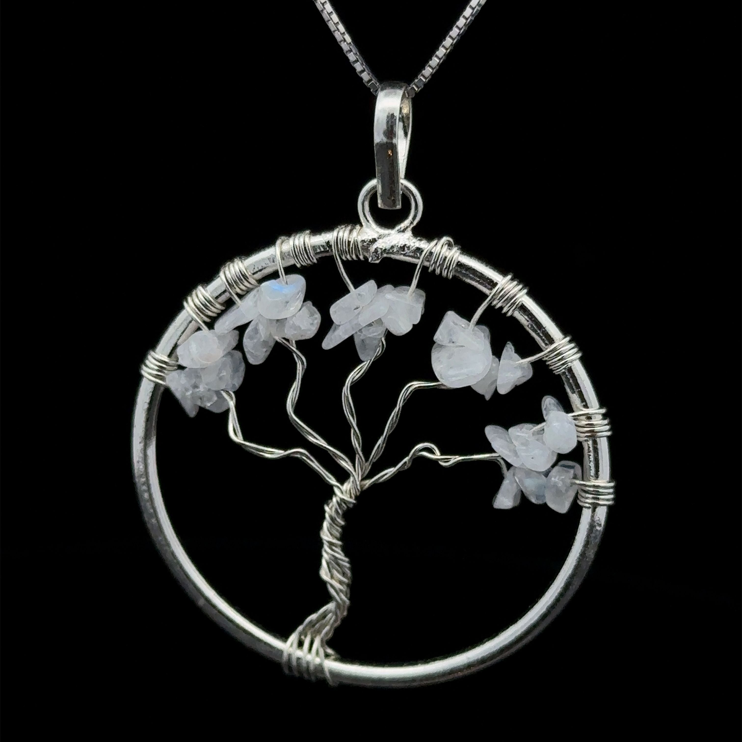 A stunning Wire Wrapped Tree of Life Pendant with Stones, featuring white gemstone leaves, suspended from a silver chain, and intricately wire wrapped for a unique touch.