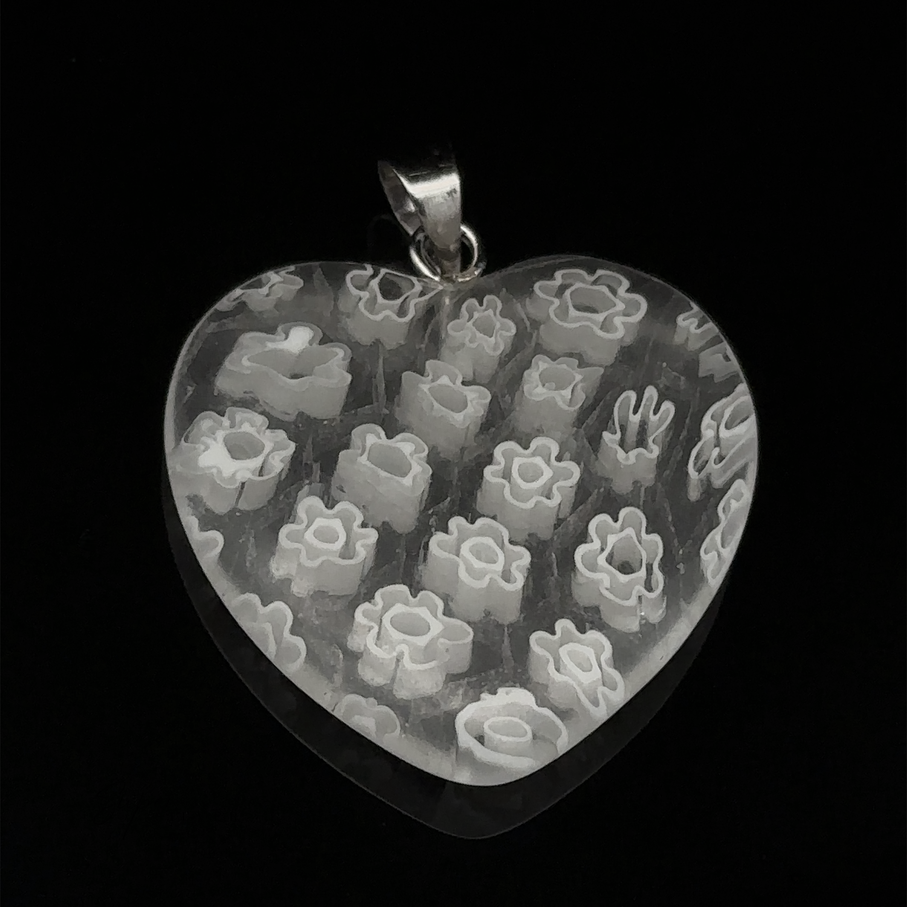 Heart Pendant with Flower Pattern. This beautiful resin heart pendant has a metallic loop at the top for attaching to a chain.