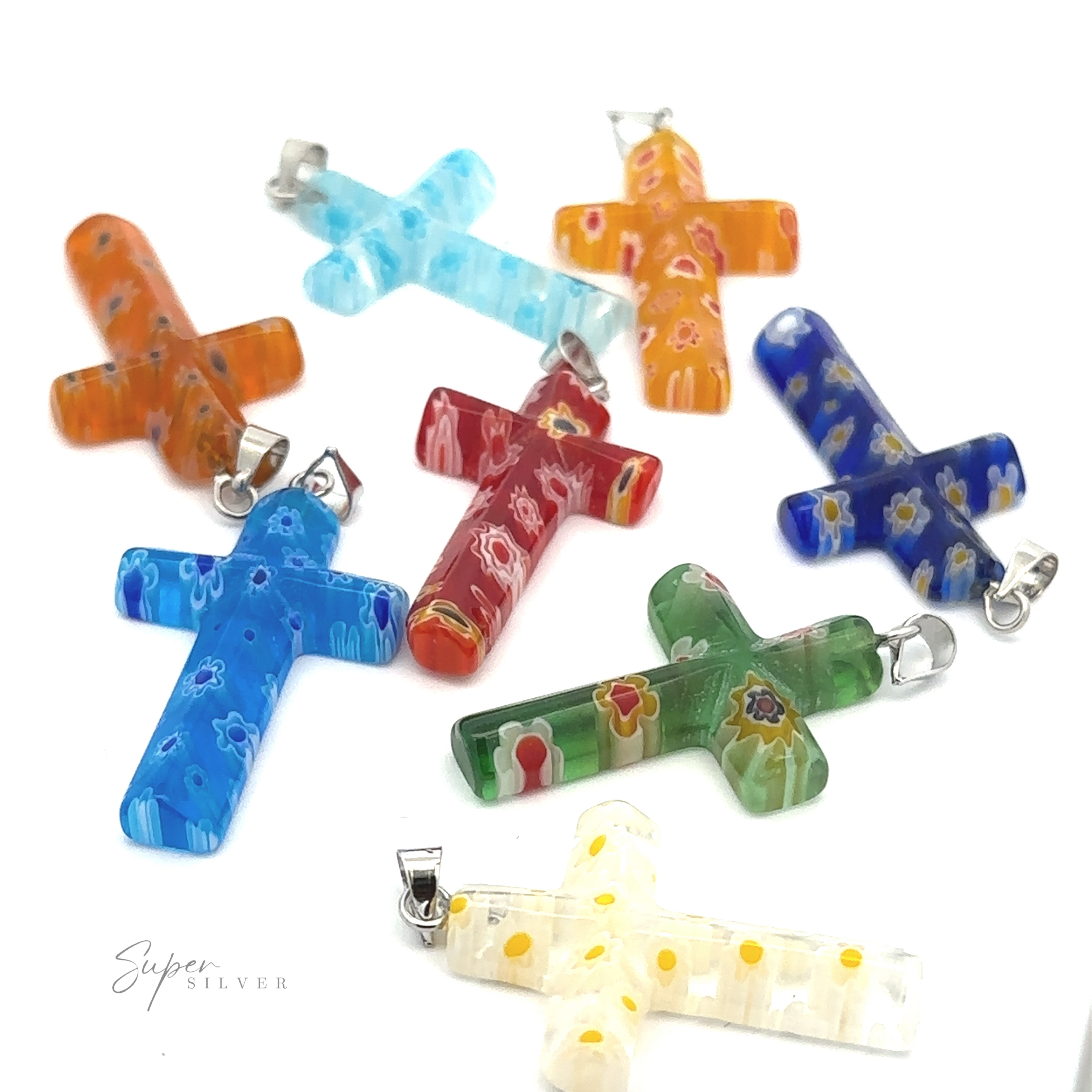 An assortment of Cross Pendants with Flower Patterns made of translucent resin, featuring various flower designs, laid out on a white background.