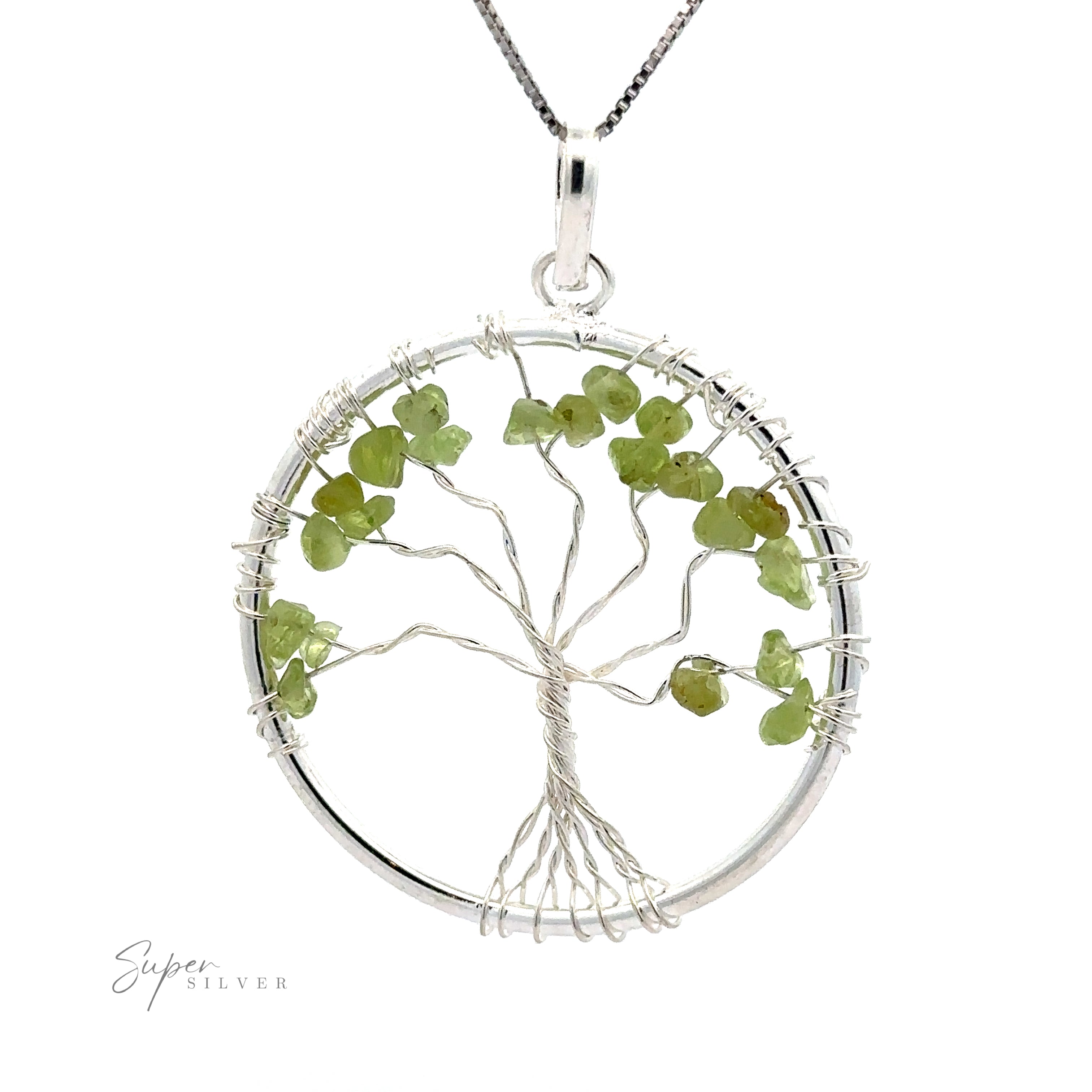 A round silver Wire Wrapped Tree of Life Pendant with Stones featuring a tree design with green gemstone leaves, elegantly suspended on a silver chain.