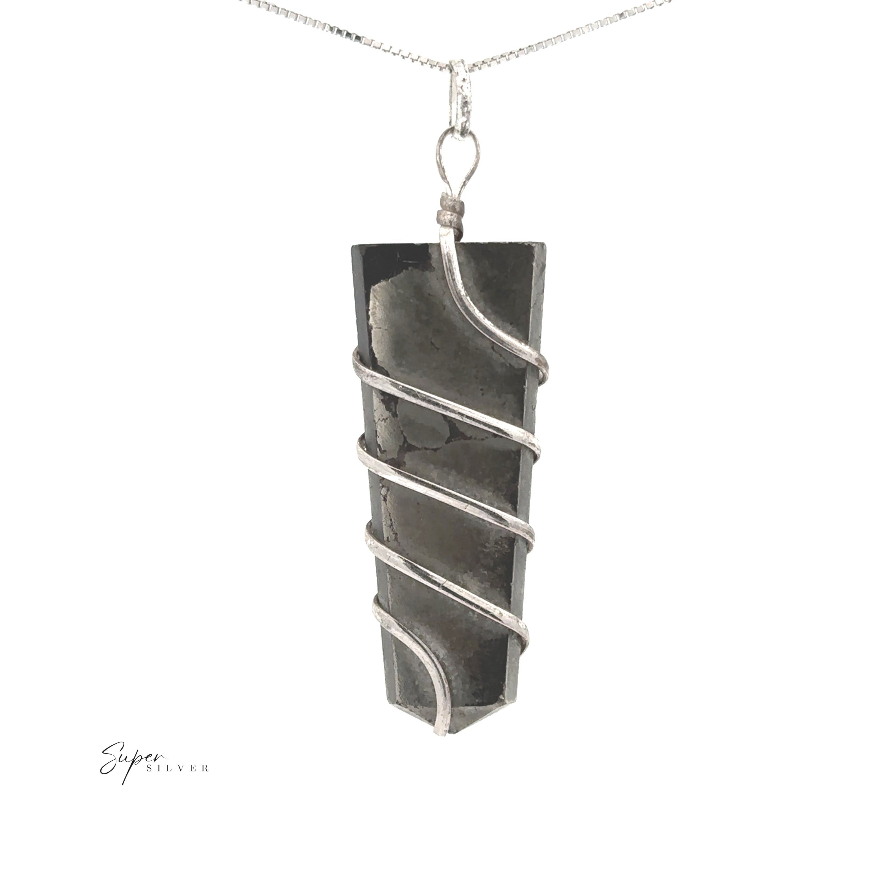 The Wire Wrapped Slab Pendant features a dark gemstone wrapped in silver and hangs from a thin silver chain, highlighting its elegant wire-wrapped design against a white background.
