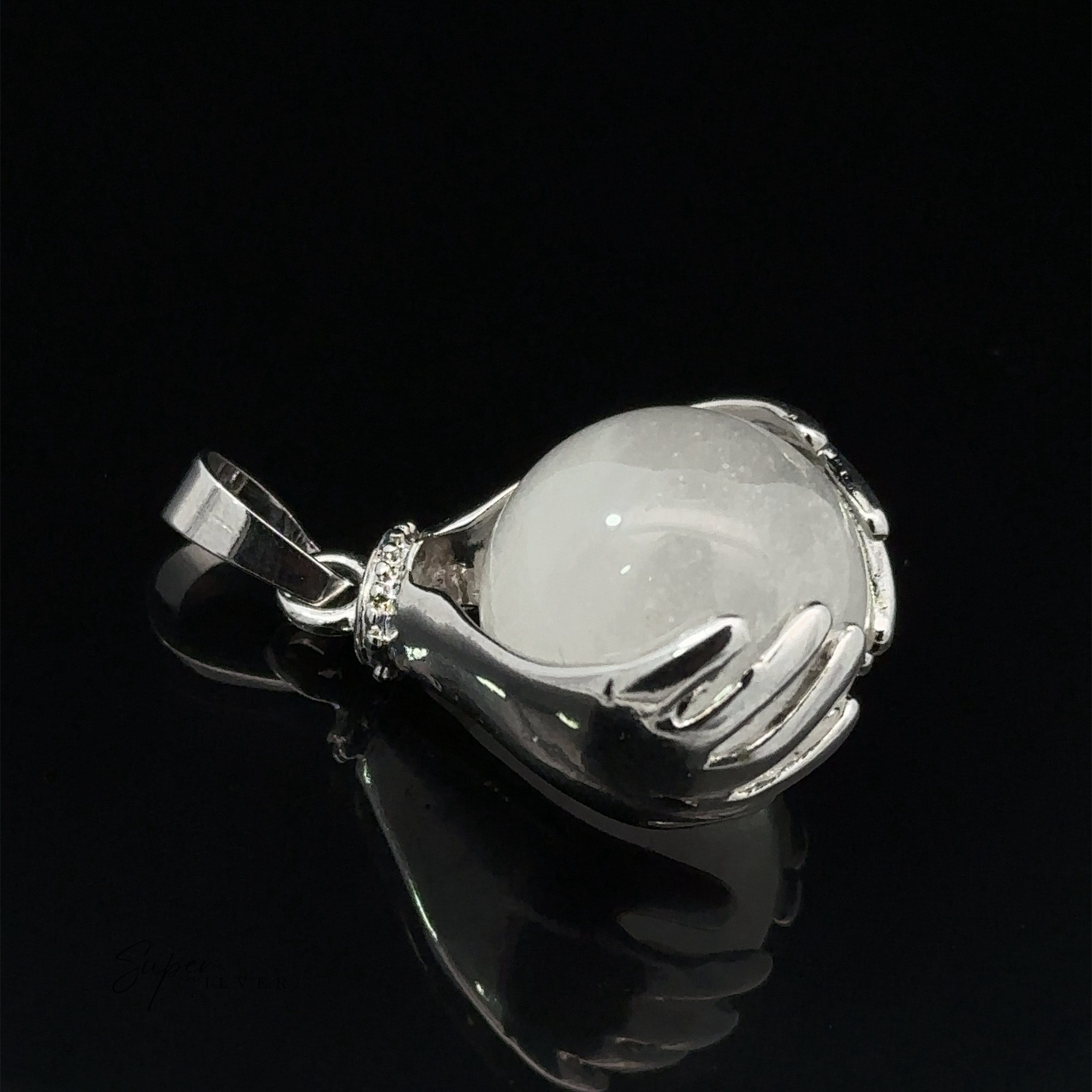 A Sphere Crystal Pendant shaped like two hands holding a white, spherical quartz stone on a black background.