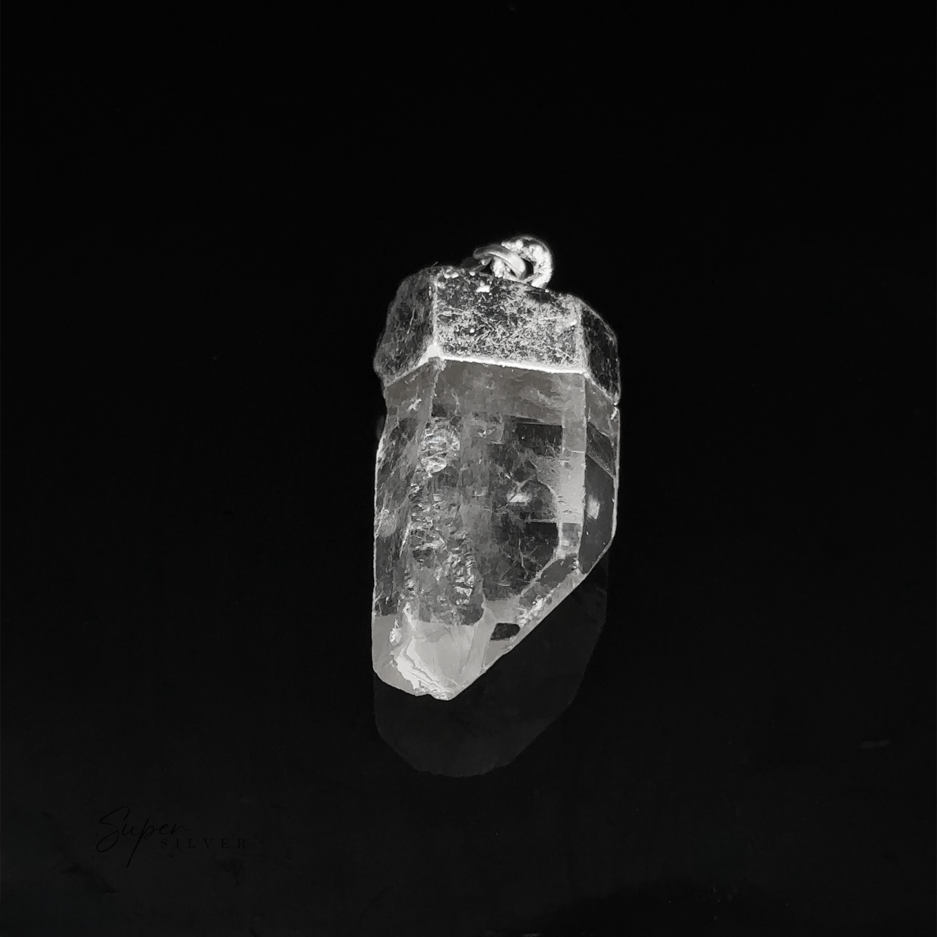 A Raw Crystal Pendant With Silver Cap featuring a transparent quartz crystal with a silver metal cap and bail, photographed against a black background.