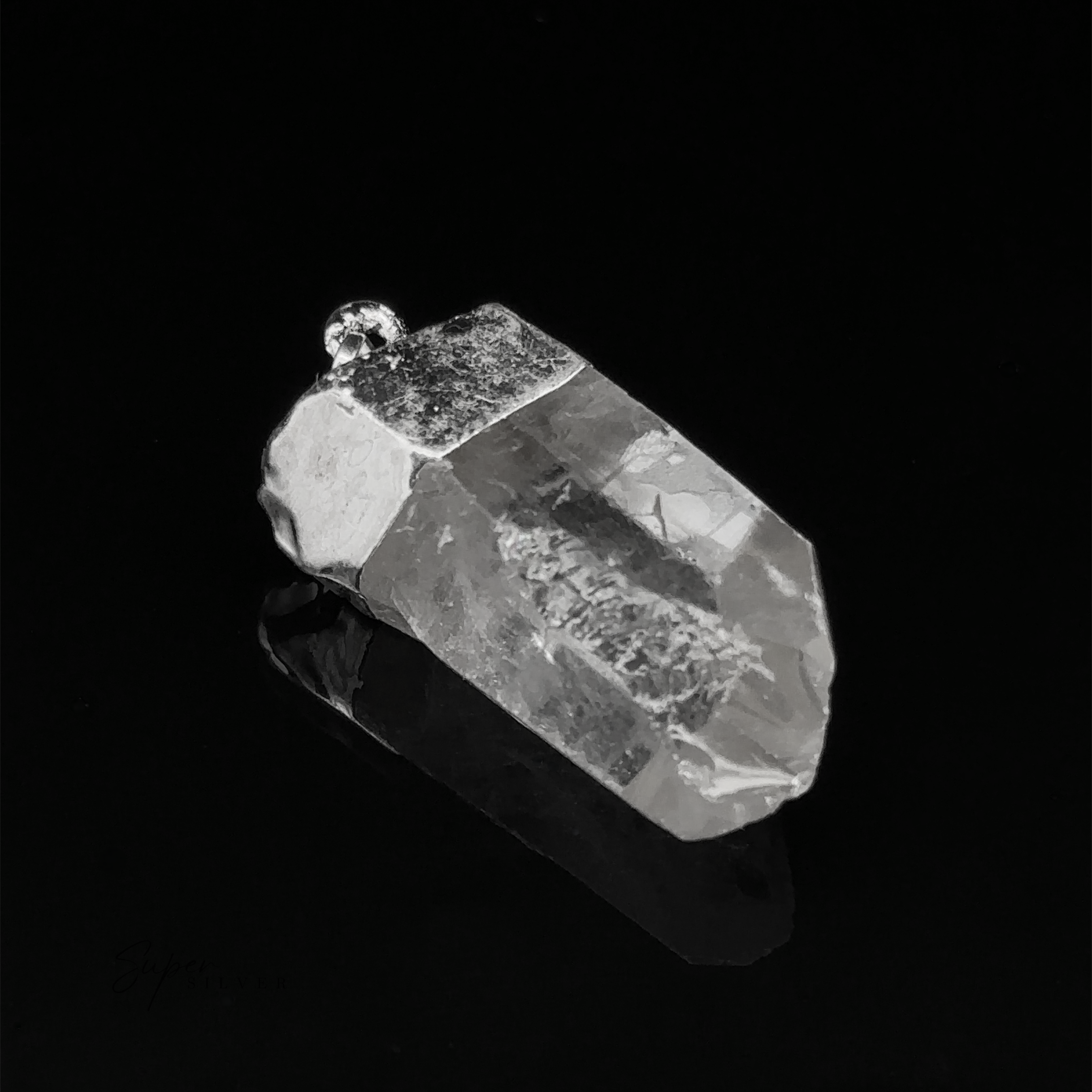 A Raw Crystal Pendant With Silver Cap showcased on a black background highlights its natural gemstone allure.