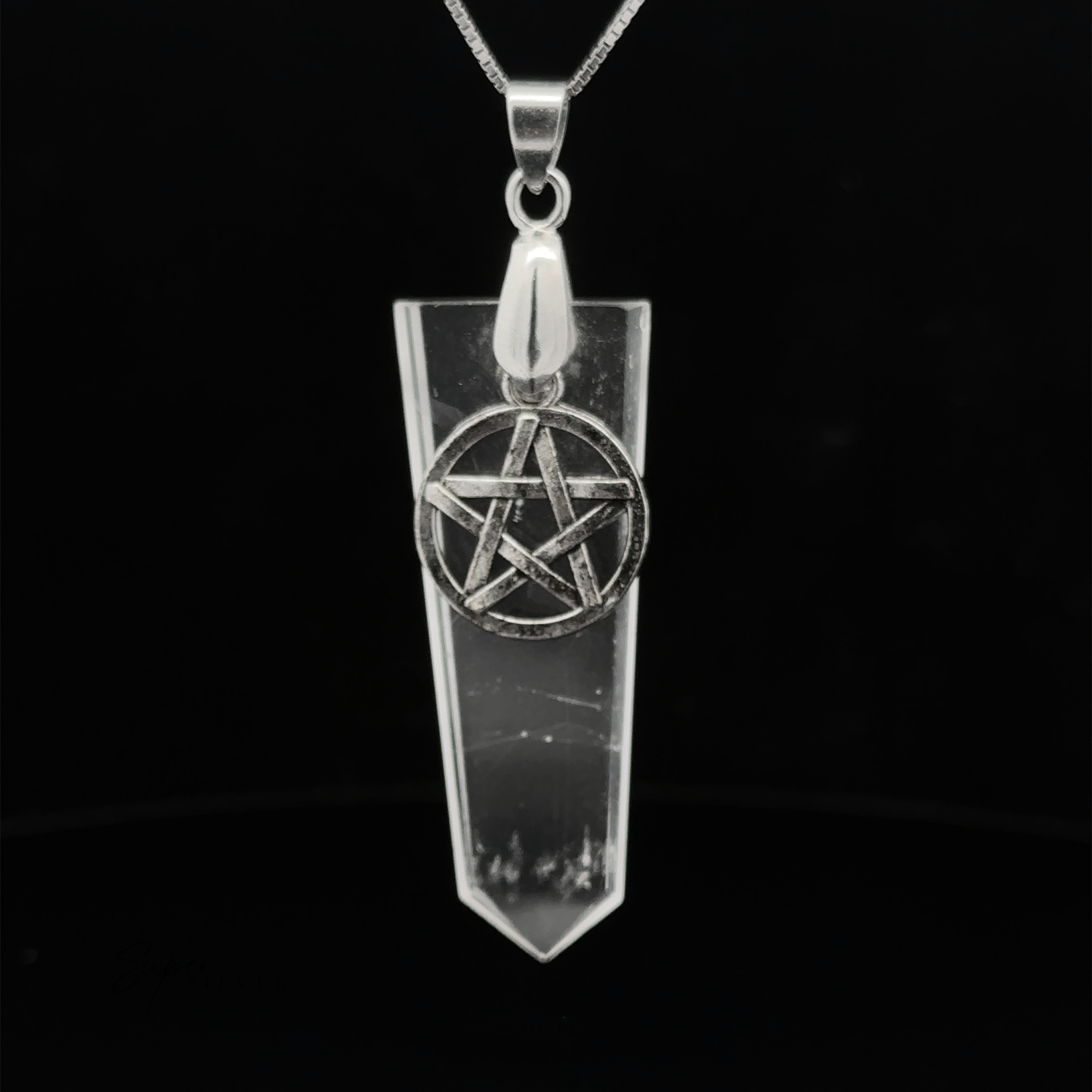 A silver necklace with a Pentagram Stone Slab Pendant hangs elegantly on a black background.